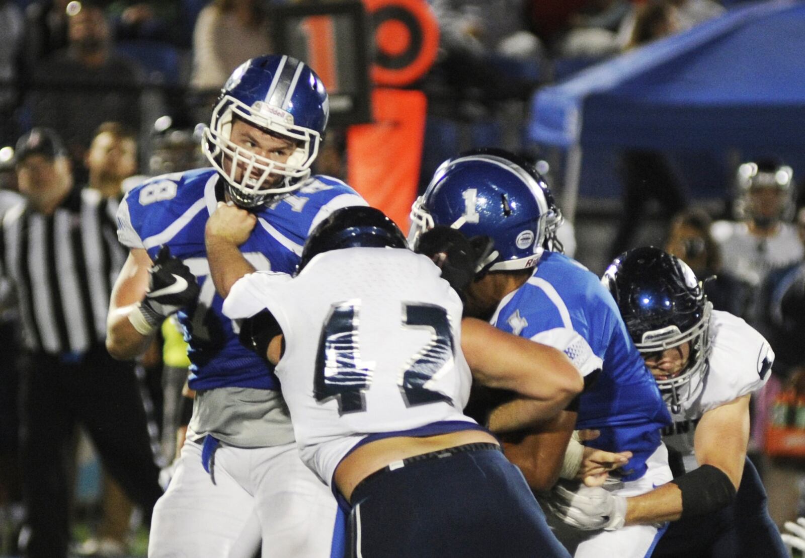 Miamisburg’s Colin Alcorn (left) and Zion Lewis (1) is met by Fairmont’s Trey Baker (42) and a teammate. Fairmont defeated host Miamisburg 25-24 in a Week 6 high school football game on Friday, Sept. 28, 2018. MARC PENDLETON / STAFF