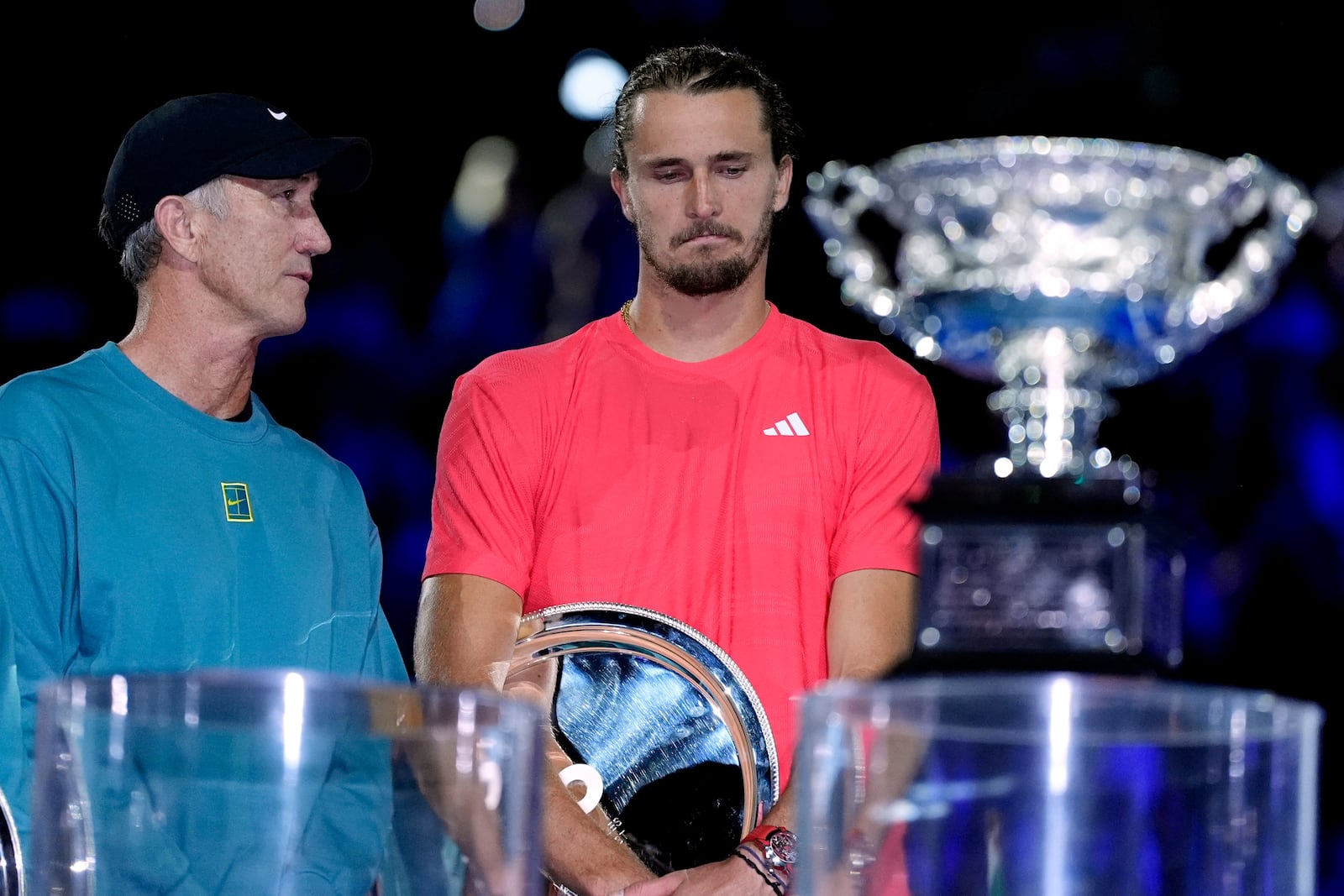 Alexander Zverev of Germany stands next to Darren Cahill, left, coach of Jannik Sinner of Italy following his loss at the Australian Open tennis championship in Melbourne, Australia, Sunday, Jan. 26, 2025. (AP Photo/Asanka Brendon Ratnayake)