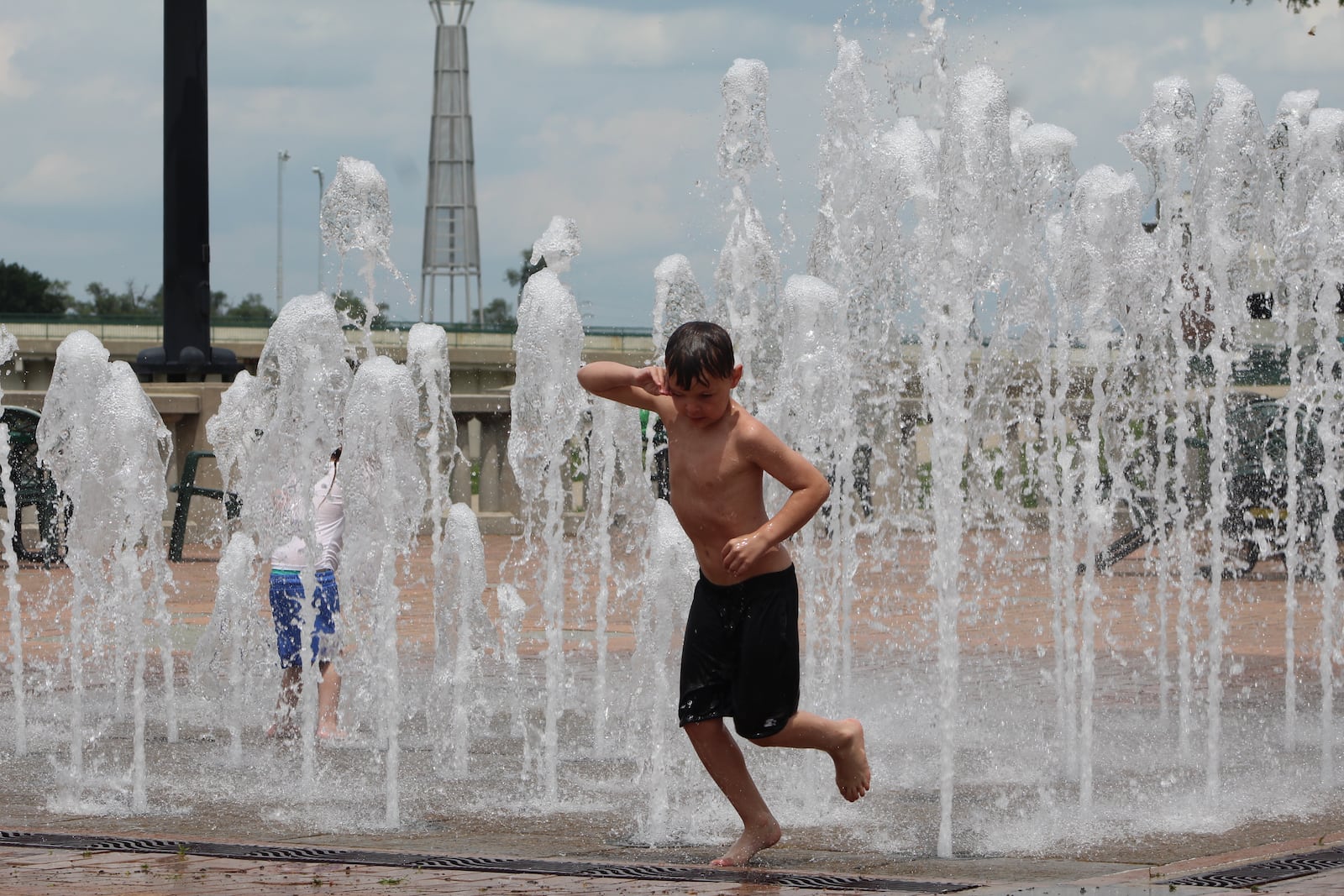 Children play in the interactive fountain at RiverScape during the week. CORNELIUS FROLIK / STAFF