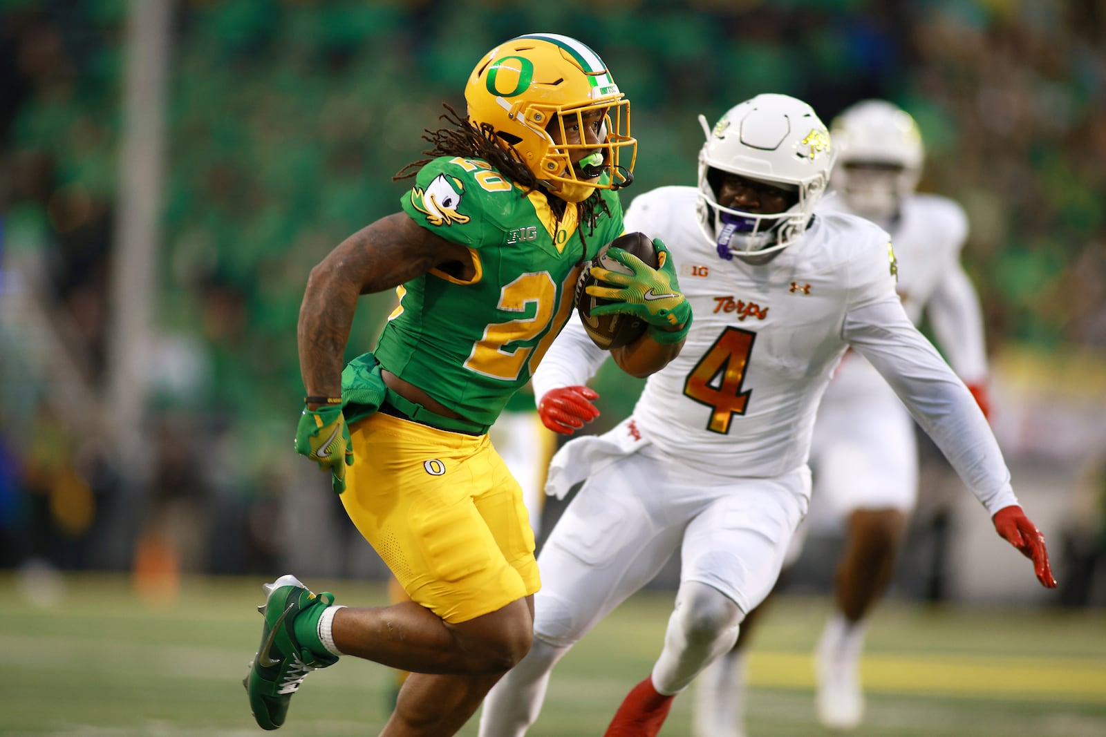 Oregon running back Jordan James (20) runs against Maryland linebacker Ruben Hyppolite II (4) during an NCAA college football game, Saturday, Nov. 9, 2024, in Eugene, Ore. (AP Photo/Lydia Ely)