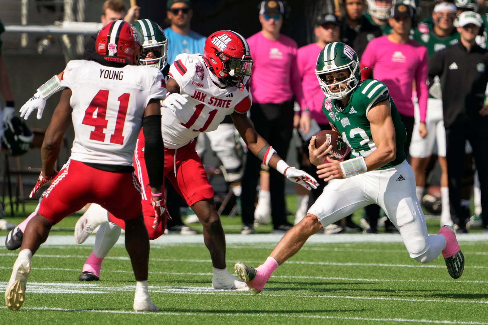 Ohio quarterback Parker Navarro (13) runs for yardage as Jacksonville State linebacker Ky'won McCray (11) and edge Curley Young Jr. (41) defend during the first half of the Cure Bowl NCAA college football game, Friday, Dec. 20, 2024, in Orlando, Fla. (AP Photo/John Raoux)