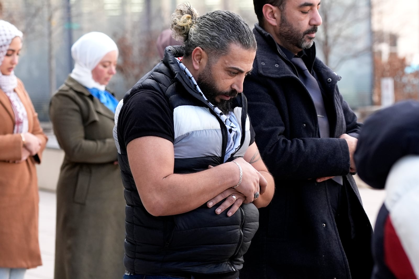 Odai Alfayoumi, father of 6-year-old Palestinian boy Wadee Alfayoumi, prays with Communications Coordinator of Council on American-Islamic Relations members, outside the Will County Courthouse where a jury found defendant Joseph Czuba found guilty of murder and hate crime charges, Friday, Feb. 28, 2025, in Joliet, Ill. (AP Photo/Nam Y. Huh)