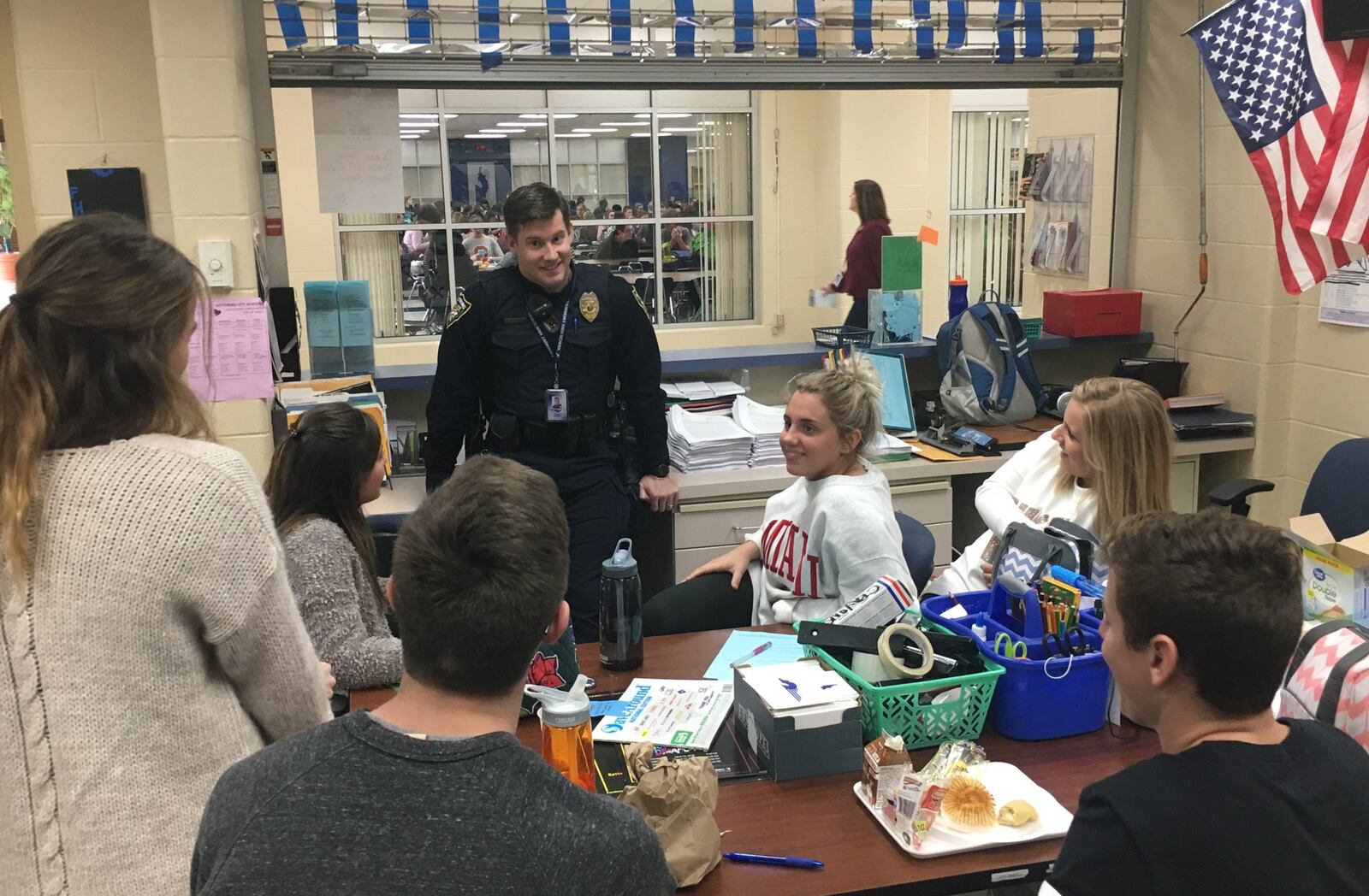 Kettering Police school resource officer Edward Drayton talks to Fairmont High School students about their day during the lunch period Thursday, Feb. 22, 2018. Drayton said daily relationship-building makes it easier for students and staff to come to him with safety concerns before they become crises. JEREMY P. KELLEY / STAFF