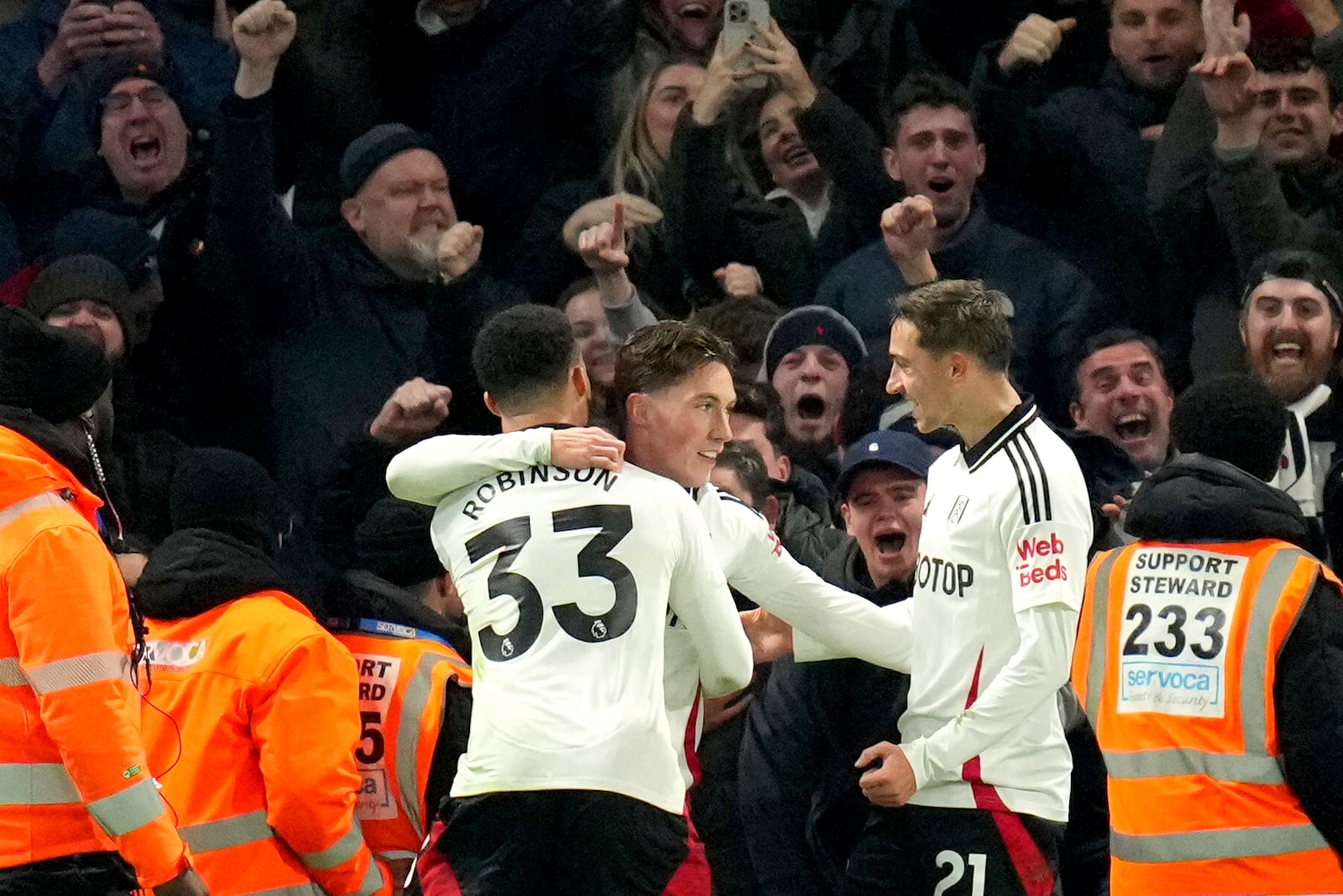 Fulham's Harry Wilson, center, celebrates after scoring his sides first goal during the English Premier League soccer match between Chelsea and Fulham at Stamford Bridge stadium in London, Thursday, Dec. 26, 2024. (AP Photo/Kirsty Wigglesworth)