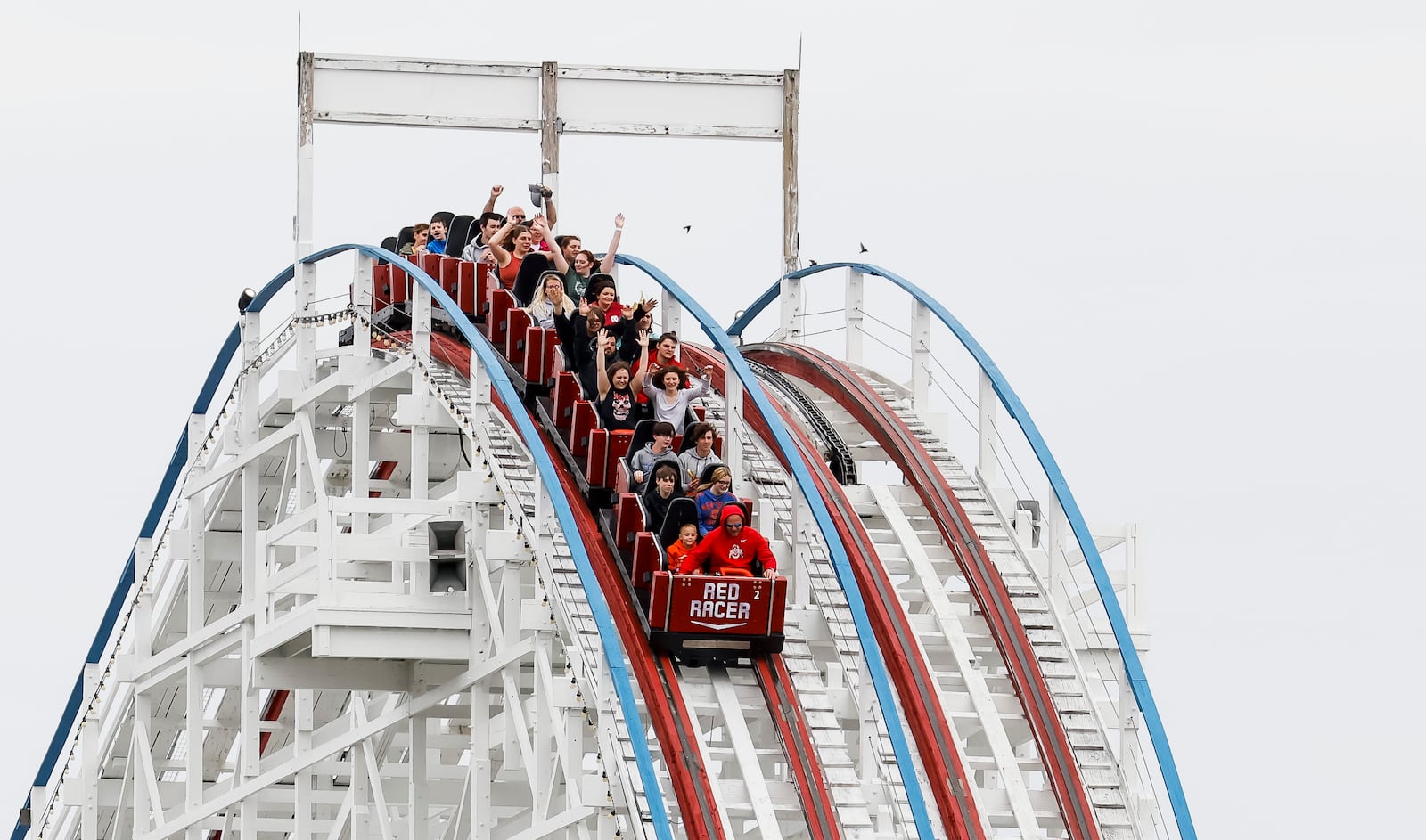 Visitors ride The Racer after Kings Island held an opening ceremony and ribbon cutting Friday, April 29, 2022 in celebration of their 50th Anniversary. NICK GRAHAM/STAFF