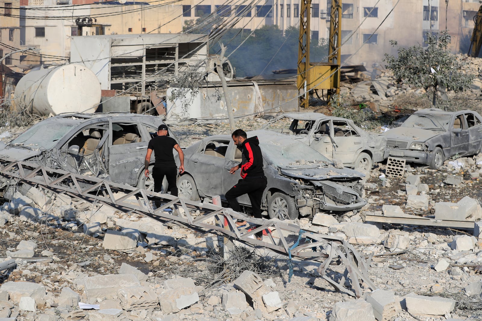 Resident check the site of an Israeli airstrike in Tyre, southern Lebanon, Saturday, Nov. 9, 2024. (AP Photo/Mohammad Zaatari)