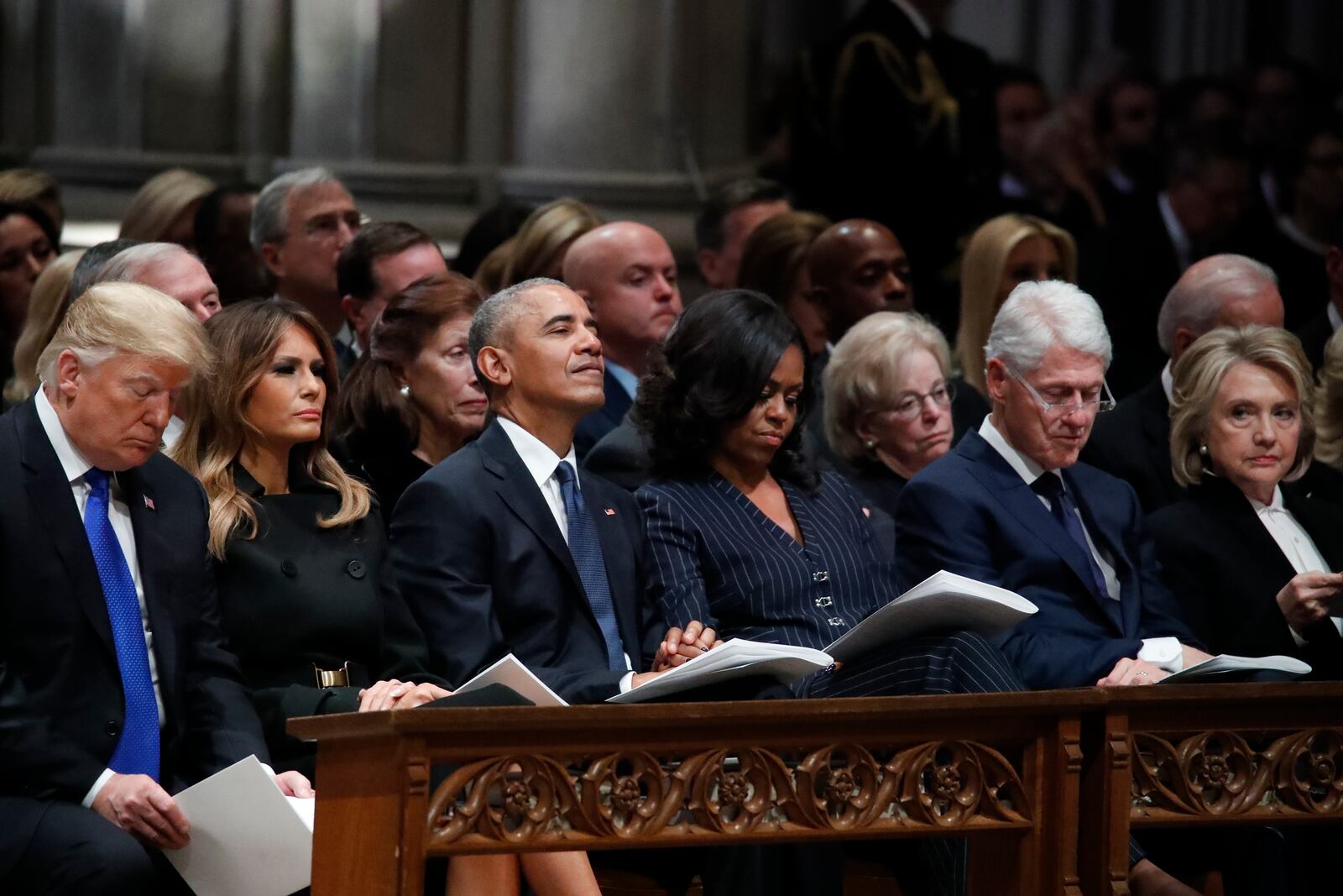 FILE - From left, President Donald Trump, first lady Melania Trump, former President Barack Obama, Michelle Obama, former President Bill Clinton and former Secretary of State Hillary Clinton listen during a State Funeral at the National Cathedral, Dec. 5, 2018, in Washington, for former President George H.W. Bush. (AP Photo/Alex Brandon, Pool, File)