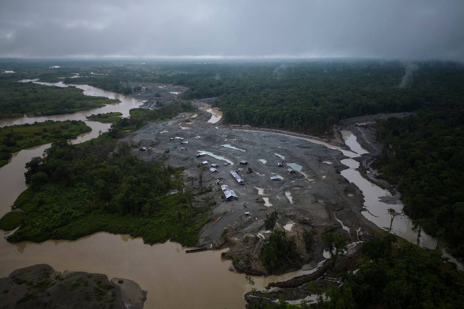 An illegal mining camp, sits along the Quito River, near Paimado, Colombia, Monday, Sept. 23, 2024. (AP Photo/Ivan Valencia)