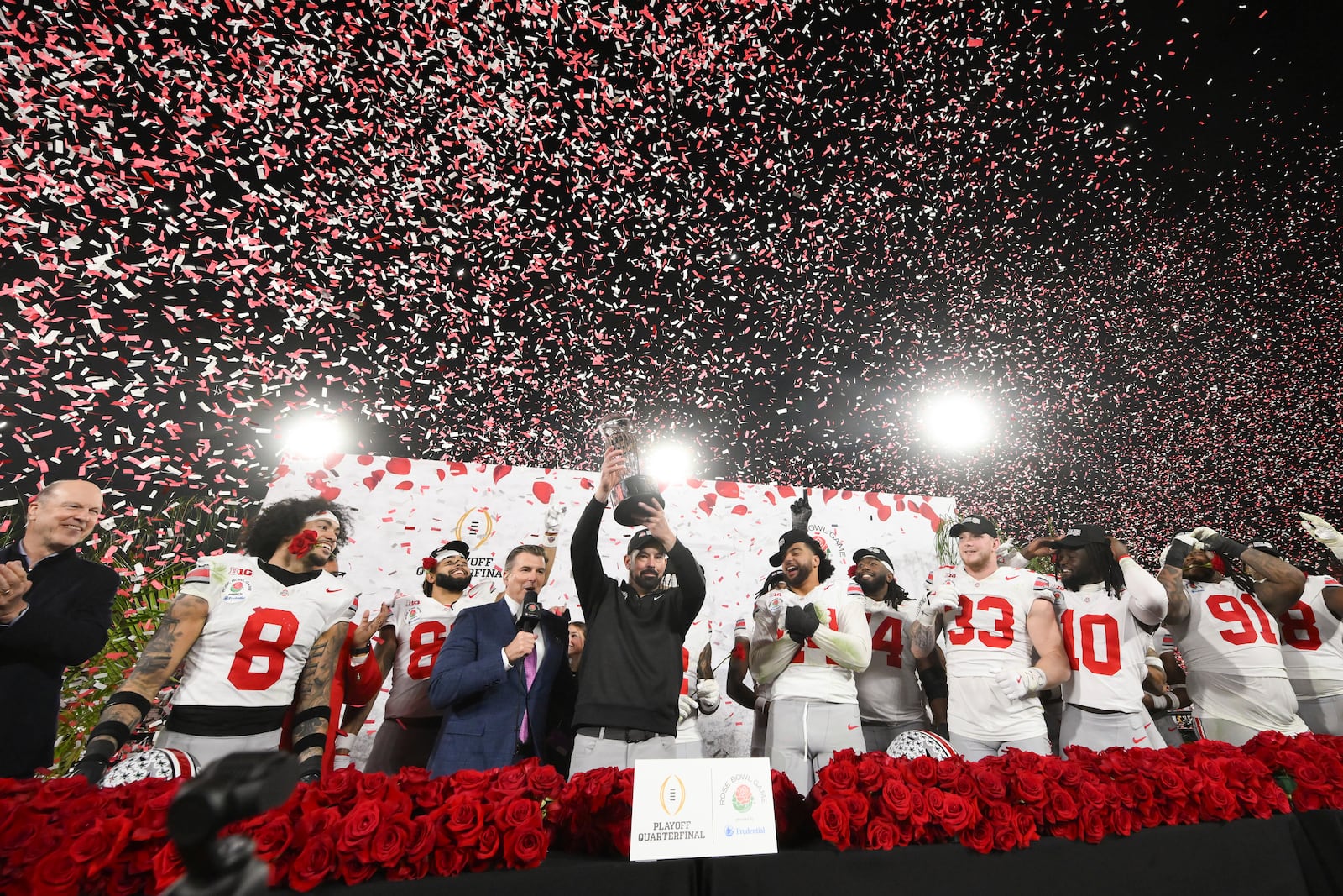 Ohio State head coach Ryan Day holds the trophy as he celebrates with his team after winning the quarterfinals of the Rose Bowl College Football Playoff against Oregon, Wednesday, Jan. 1, 2025, in Pasadena, Calif. (AP Photo/Kyusung Gong)