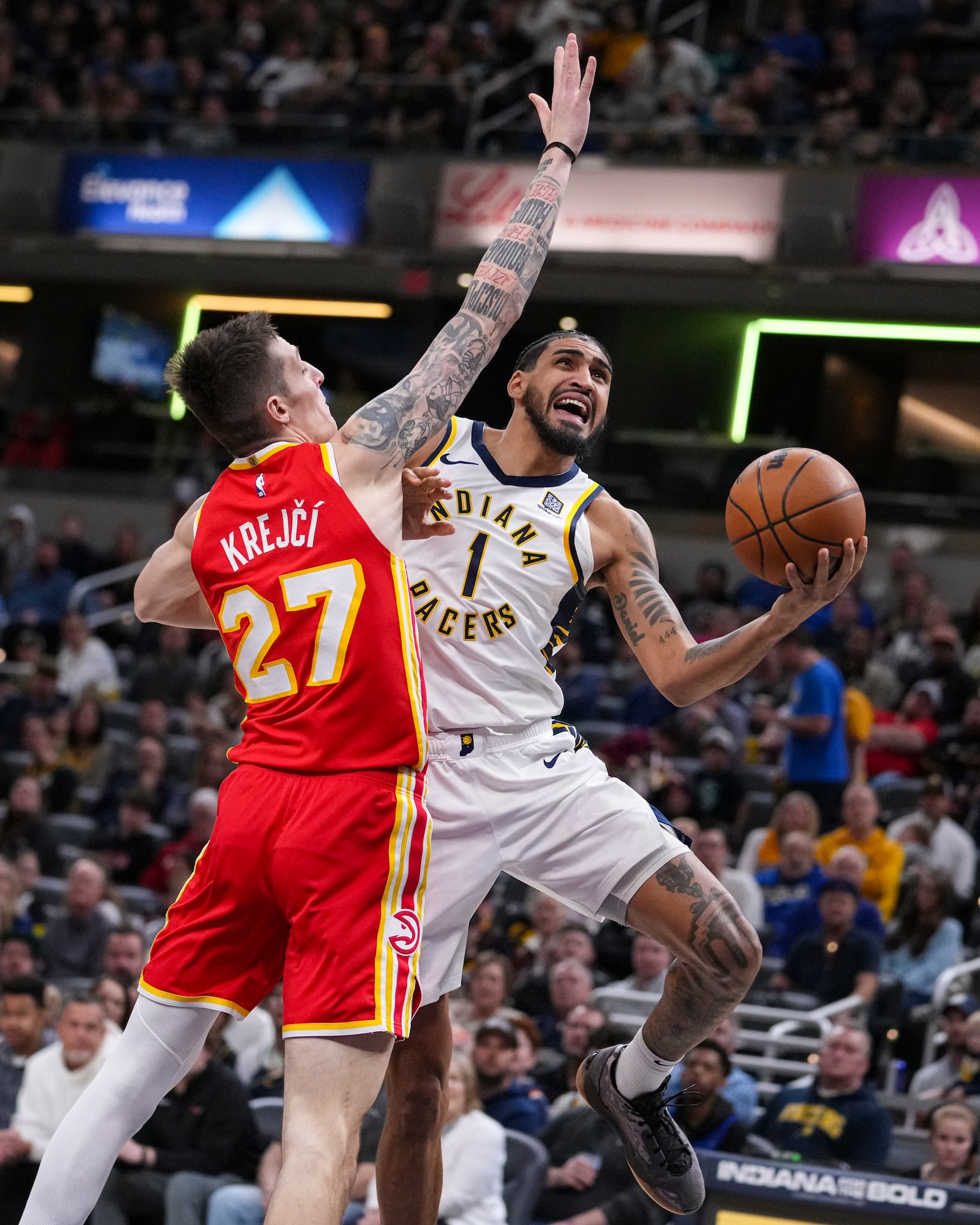 Indiana Pacers forward Obi Toppin (1) shoots around Atlanta Hawks guard Vit Krejci (27) during the second half of an NBA basketball game in Indianapolis, Saturday, Feb. 1, 2025. (AP Photo/Michael Conroy)