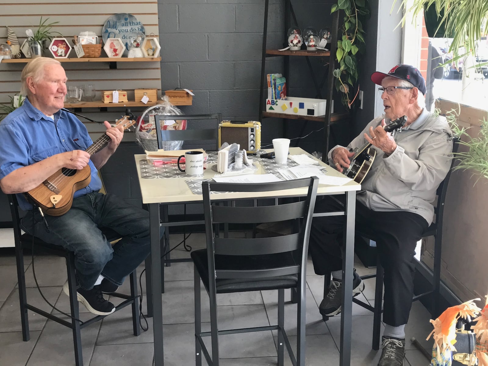 Dale Bufler (right) and Don Armbruster performing at Mary & Clyde’s Revisited  Deli, Bait & Tackle shop on Main Street in Hamilton. Tom Archdeacon/CONTRIBUTED