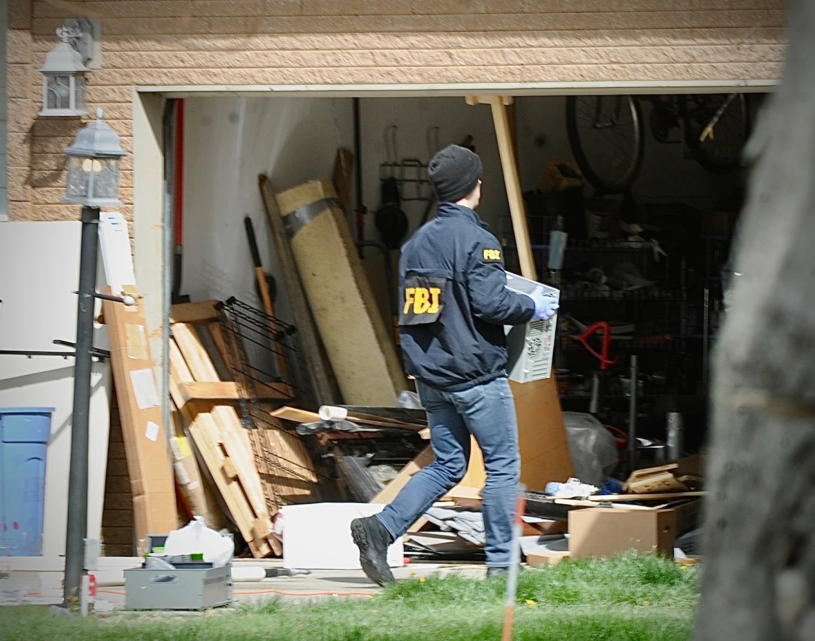 Several local law-enforcement agencies and the FBI go through a home on Barnhart Road in Troy Friday morning, April 5, 2024. MARSHALL GORBY \STAFF