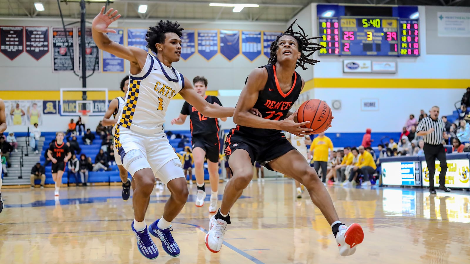 Beavercreek High School senior Isaiah-Michael Williams is guarded by Springfield's CJ Wallace during their game on Friday, Jan. 14 at Springfield High School. CONTRIBUTED PHOTO BY MICHAEL COOPER