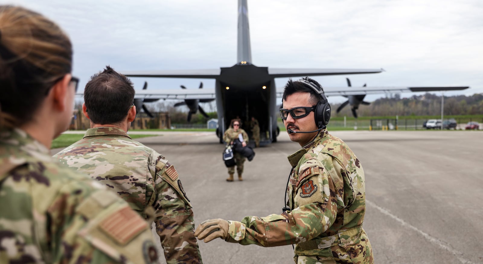 U.S. Air Force Senior Master Sgt. Joseph Valenzuela, right, 445th Aeromedical Evacuation Squadron medical technician, directs U.S. Air Force critical care air transport teams (CCATTs) back to the aircraft to offload mannequin patients at the Cincinnati Municipal Airport, April 6, 2023. The CCATTs trained with the 445th Aeromedical Evacuation Squadron on trauma and critical care aboard an aircraft as part of the Center for the Sustainment of Trauma and Readiness Skills (C-STARS) program at the University of Cincinnati Medical Center. A U.S. Air Force C-130J Hercules aircraft with the Air National Guard’s 123rd Airlift Wing out of Louisville, Kentucky, provided the backdrop for training. (U.S. Air Force photo by Master. Sgt. Patrick O’Reilly)