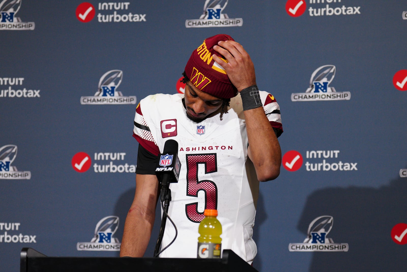 Washington Commanders quarterback Jayden Daniels adjusts his cap during a news conference after the NFC Championship NFL football game against the Philadelphia Eagles, Sunday, Jan. 26, 2025, in Philadelphia. (AP Photo/Derik Hamilton)