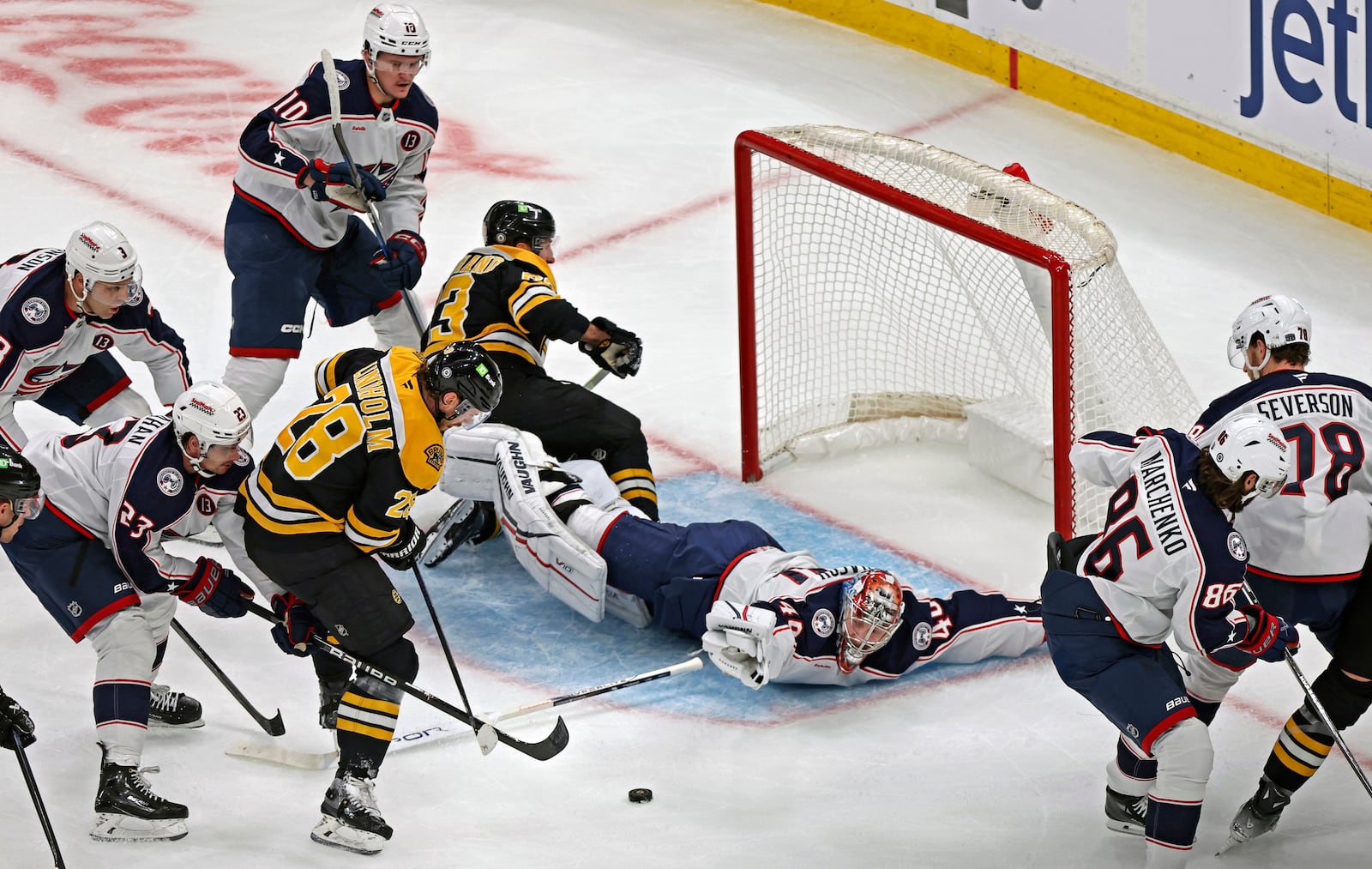 Boston Bruins forward Elias Lindholm (28) cannot get the puck past Columbus Blue Jackets goalie Daniil Tarasov (40) during the second period of an NHL hockey game Saturday, Dec. 28, 2024, in Boston. (AP Photo/Jim Davis)