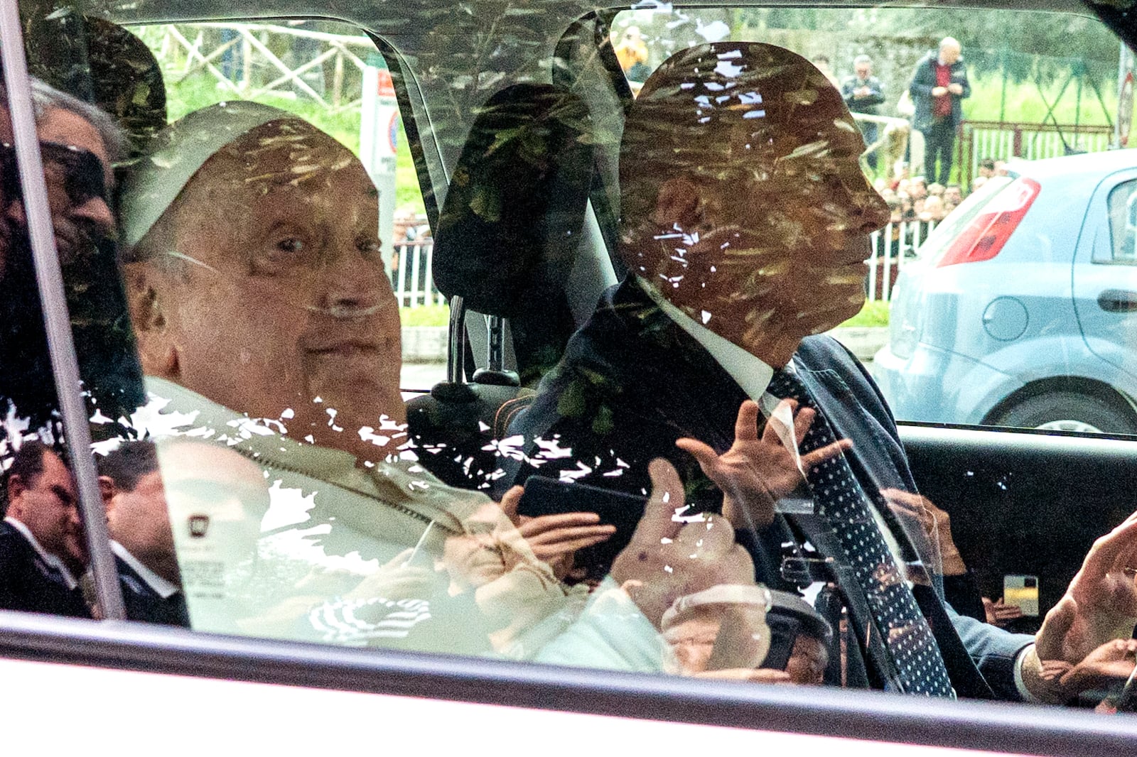 Pope Francis leaves on a car after appearing at a window of the Agostino Gemelli Polyclinic in Rome, Sunday, March 23, 2025, where he has been treated for bronchitis and bilateral pneumonia since Feb. 14. (AP Photo/Stefano Costantino)