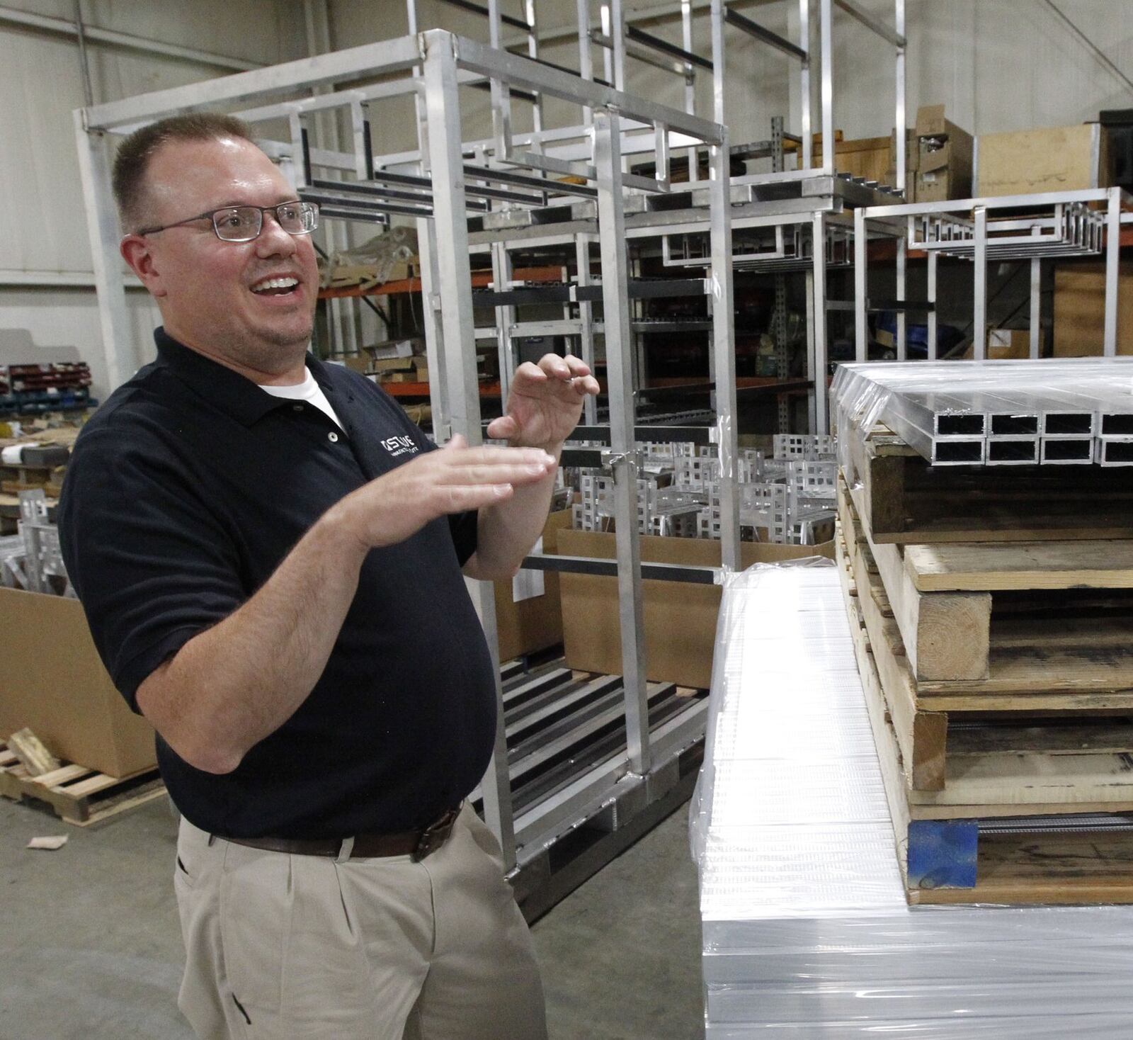 Staub Manufacturing Solutions president and co-owner Steve Staub with parts in the company’s shipping warehouse. Staub employs 40 people at the plant, which uses laser cutting machines to fabricate metal parts. TY GREENLEES / STAFF