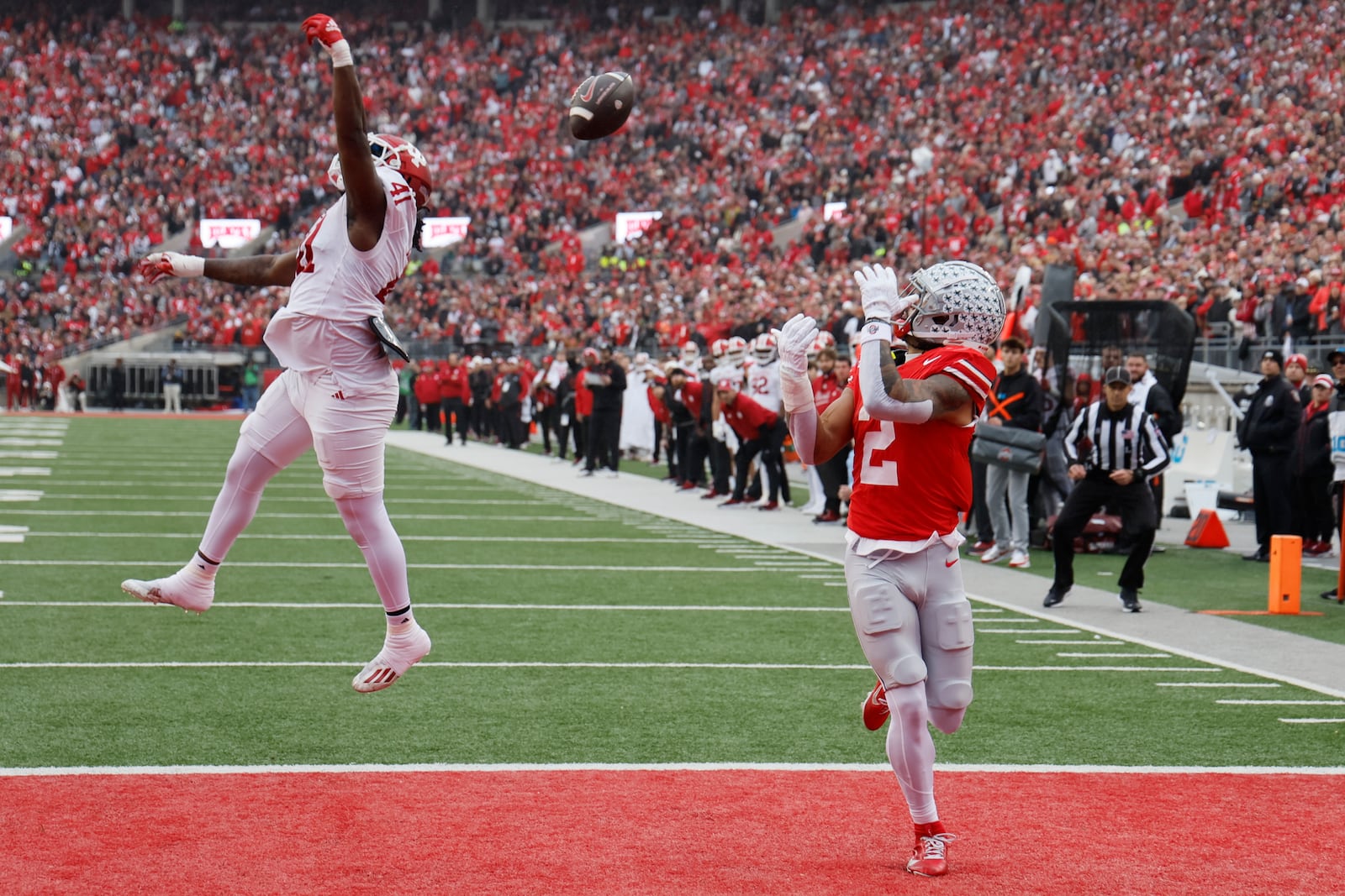 Ohio State receiver Emeka Egbuka, right, catches a touchdown pass thrown over Indiana defensive lineman Lanell Carr during the first half of an NCAA college football game Saturday, Nov. 23, 2024, in Columbus, Ohio. (AP Photo/Jay LaPrete)