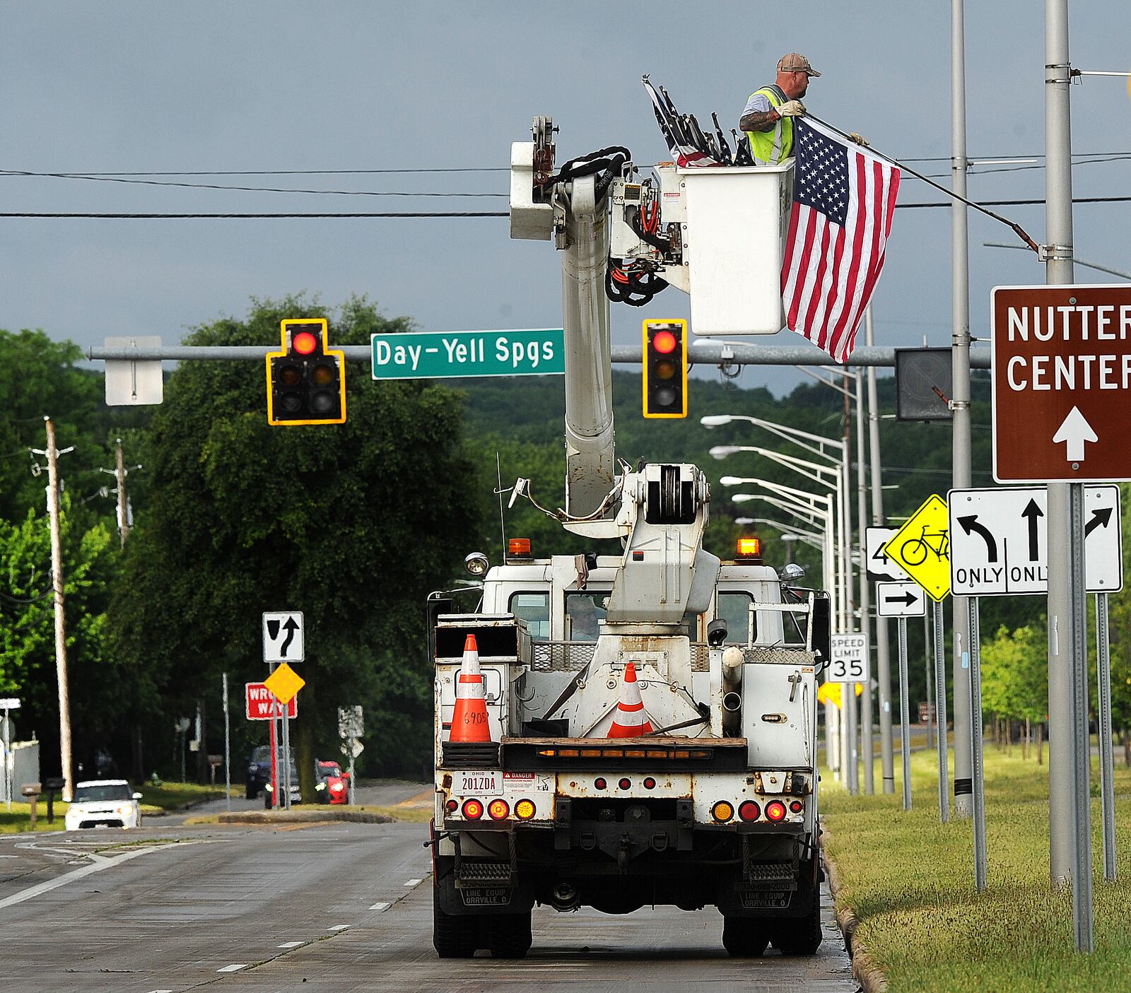 Joe Jenkins, a city of Fairborn employee, places flags along Kauffman Ave. in honor of Flag Day, on Wednesday morning,  June 14, 2023. MARSHALL GORBY\STAFF