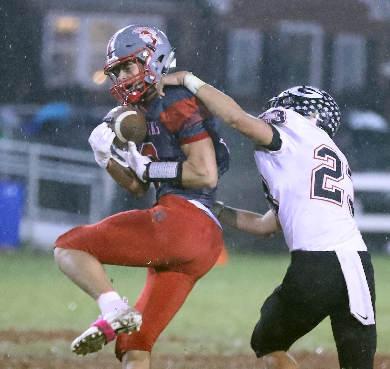 Southeastern’s Charlie Bertemes catches a pass under pressure from Greenon’s Kameron Cox. BILL LACKEY/STAFF