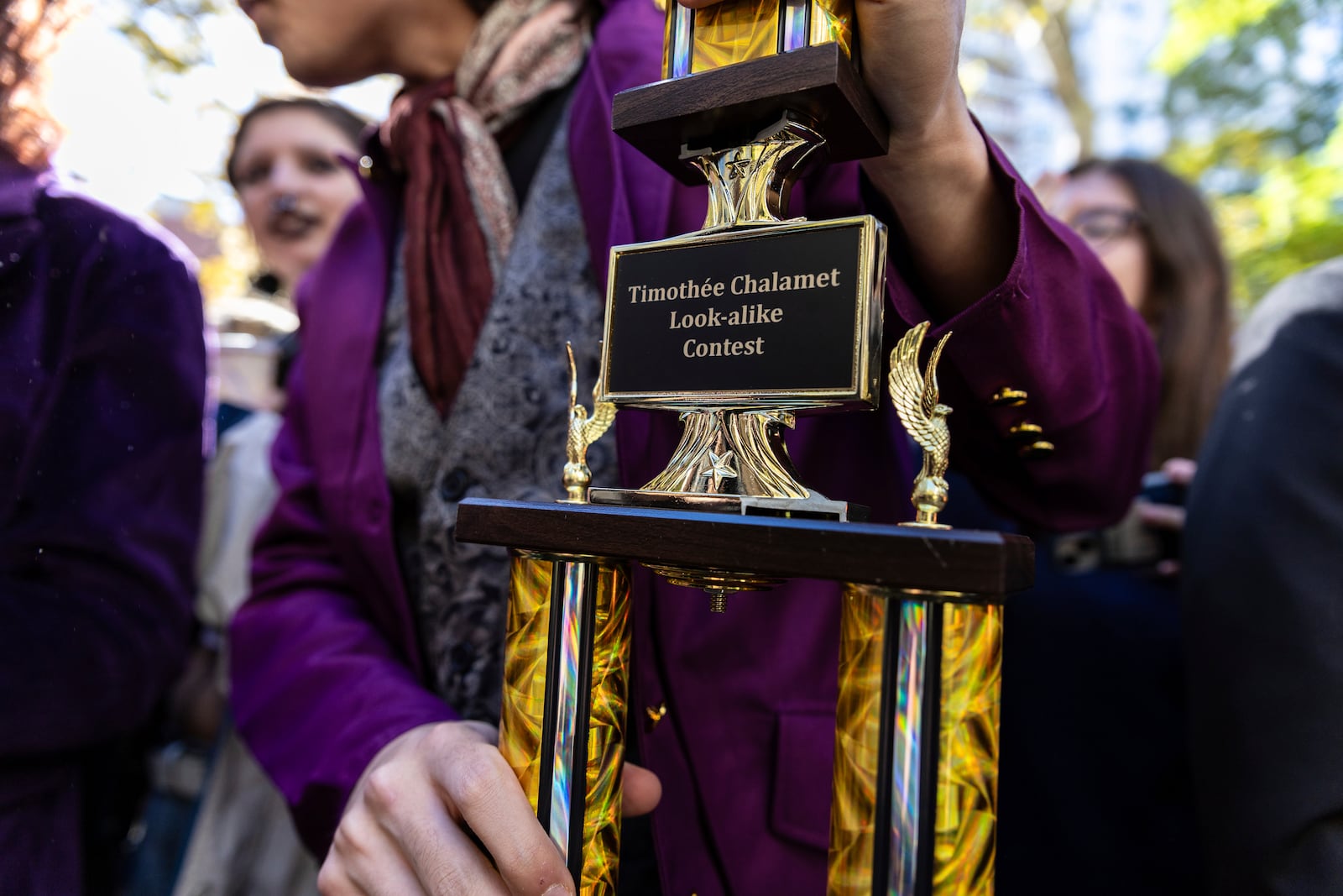 Miles Mitchell, 21, winner of the Timothee Chalomet lookalike contest, holds his trophy near Washington Square Park, Sunday, Oct. 27, 2024, in New York. (AP Photo/Stefan Jeremiah)