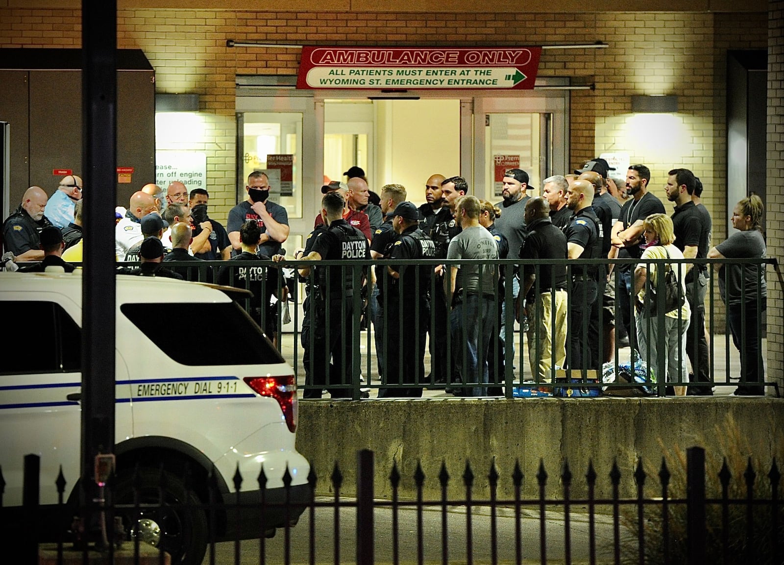 Police wait outside emergency room doors at Miami Valley Hospital Thursday night, Sept. 21, 2021, after a Dayton police officer was shot in the left temporal artery before returning fire and striking the suspect three times. The officer, later identified as Thadeu Holloway, had to medically retire due to his injuries. The suspect, Antwyane Lowe, pleaded guilty to charges and was sentenced June 6, 2023, to more than three decades in prison. MARSHALL GORBY\STAFF