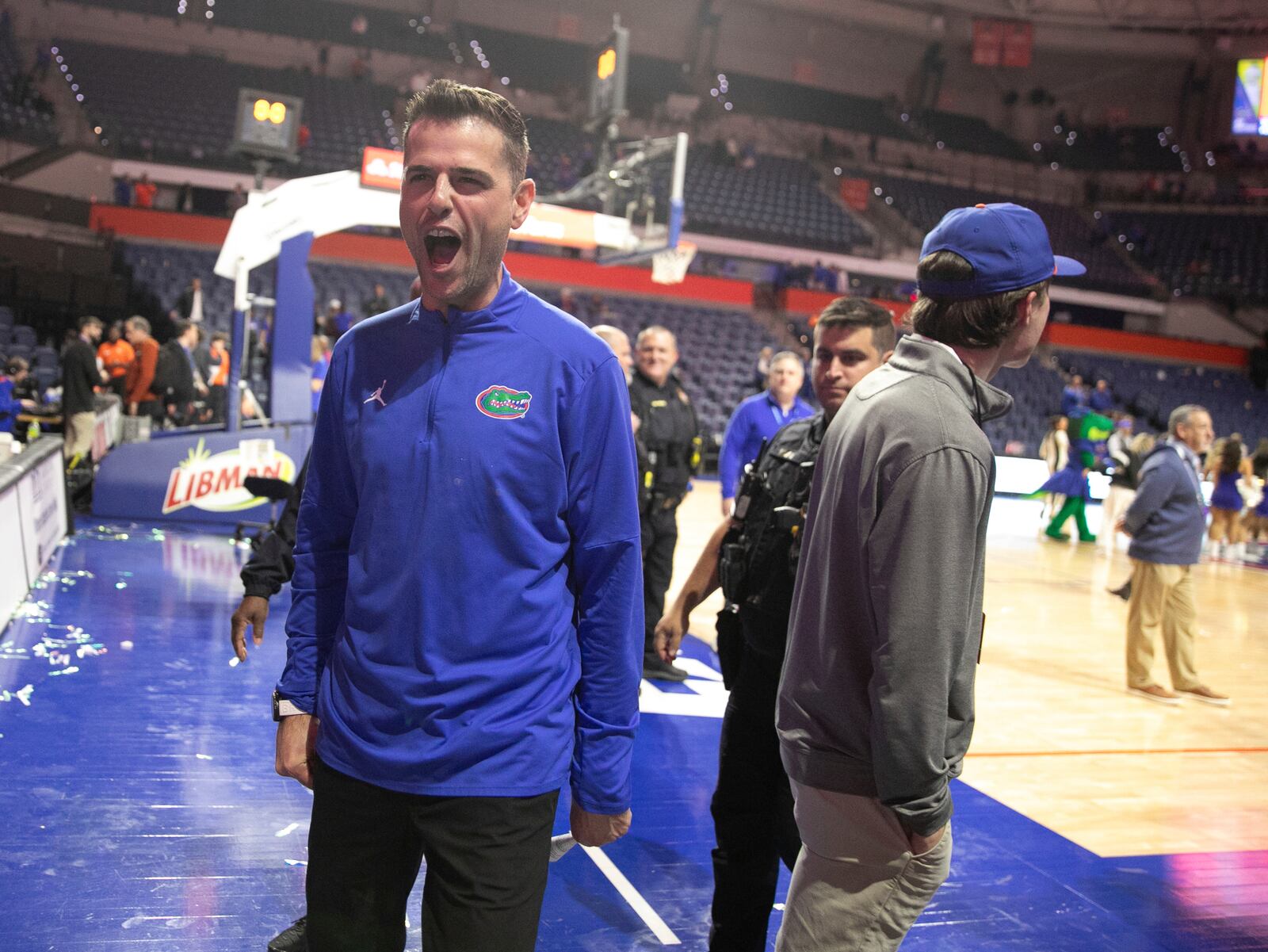 Florida head coach Todd Golden celebrates with fan after defeating Tennessee 73-43 in an NCAA college basketball game Tuesday, Jan. 7, 2025, in Gainesville, Fla. (AP Photo/Alan Youngblood)