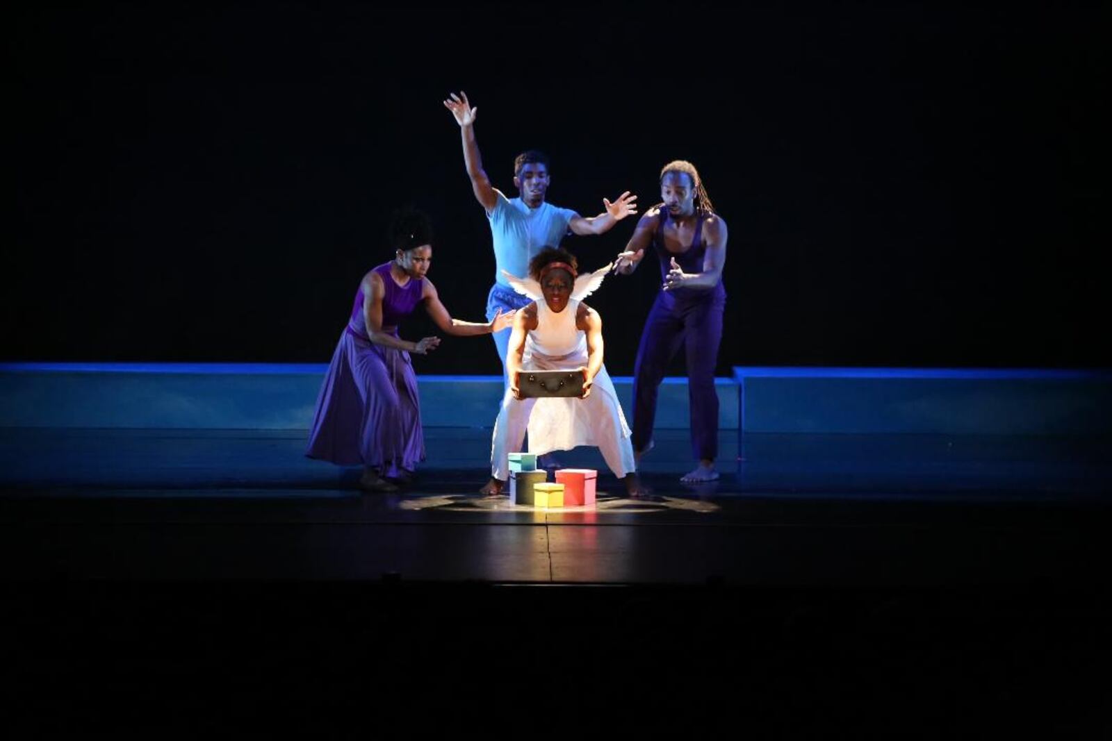 Countess Winfrey places her gift atop the presents as guardians Sheri "Sparkle" Williams, Matthew Talley and Devin Baker surround her with concern in DCDC's presentation of "The Littlest Angel."