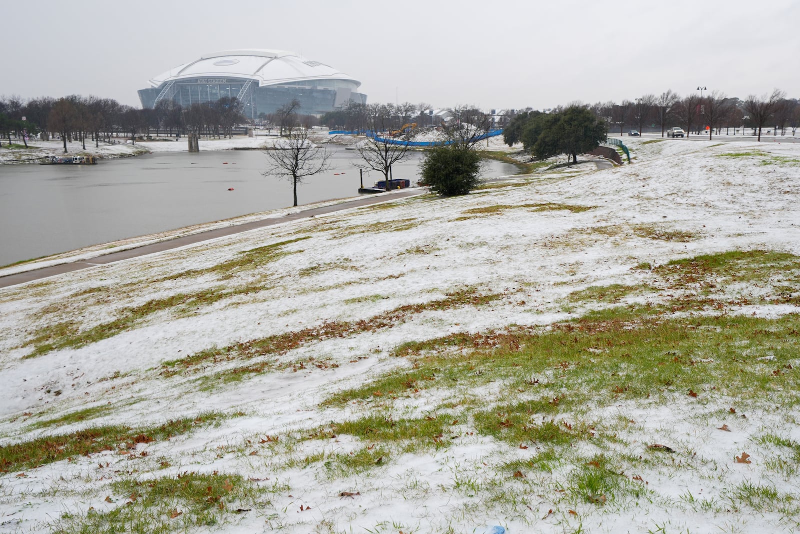 Snow is accumulated near AT&T Stadium a day prior to the Cotton Bowl NCAA College Football Playoff semifinal game between Ohio State and Texas, Thursday, Jan. 9, 2025, in Arlington, Texas. (AP Photo/Julio Cortez)