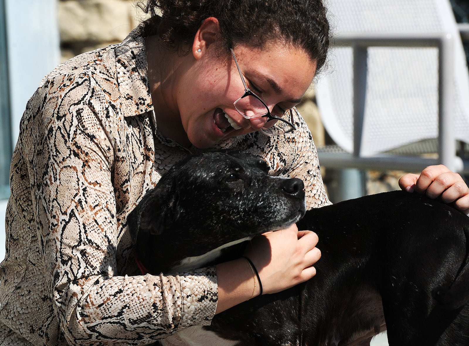 Doolis cuddles against Kara Hamby, a Montgomery County public information officer for the animal resource center.  MARSHALL GORBY\STAFF