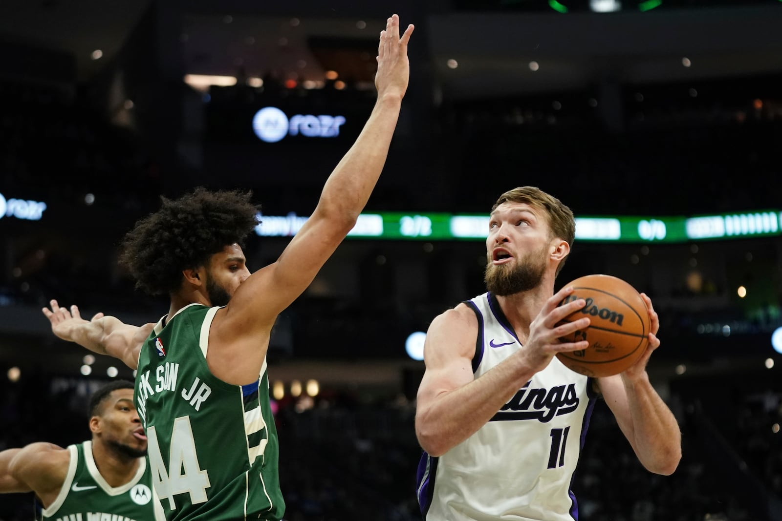 Sacramento Kings' Domantas Sabonis (11) looks to shoot against Milwaukee Bucks' Andre Jackson Jr. during the first half of an NBA basketball game. Tuesday, Jan. 14, 2025, in Milwaukee. (AP Photo/Aaron Gash)