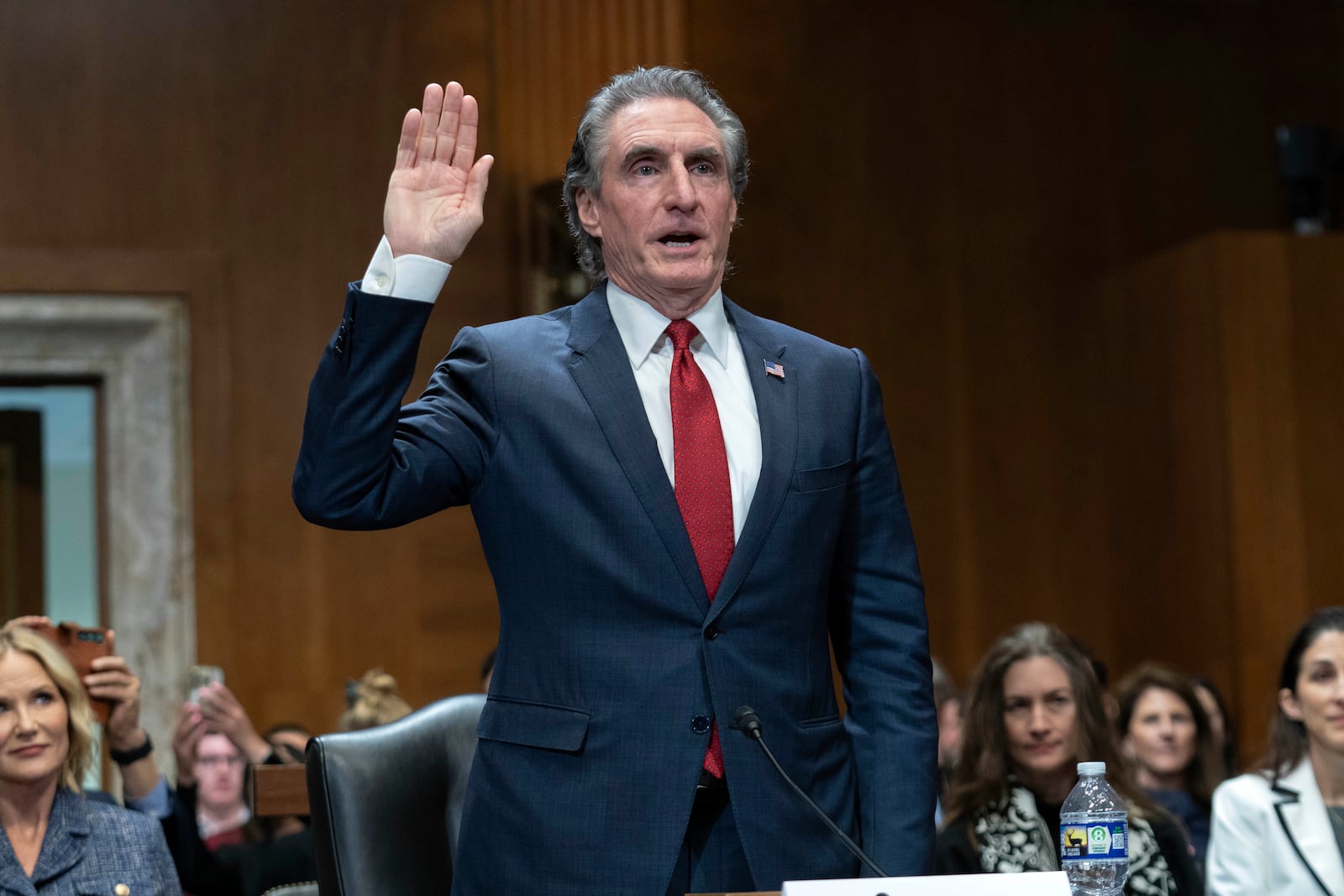 Former Gov. Doug Burgum, President-elect Donald Trump's choice to lead the the Interior Department as Secretary of the Interior, is sworn-in as he testifies before the Senate Energy and Natural Resources Committee on Capitol Hill in Washington, Thursday, Jan. 16, 2025. (AP Photo/Jose Luis Magana)