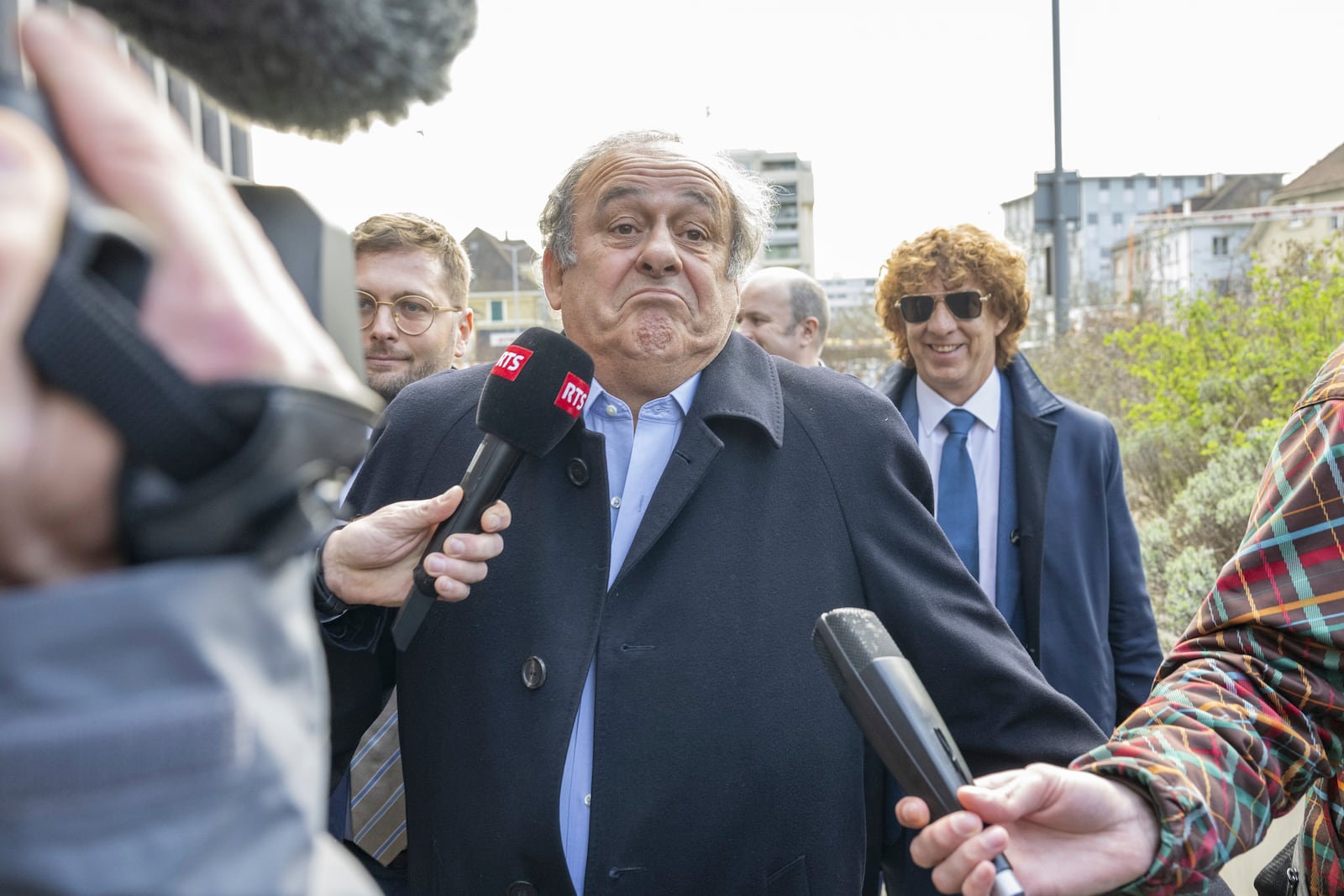 Former UEFA President, Michel Platini, centre, and his Lawyer Dominic Nellen, left, arriving to the verdict at the special appeals court, in Muttenz, Switzerland, Tuesday, March 25, 2025. (Urs Flueeler/Keystone via AP)