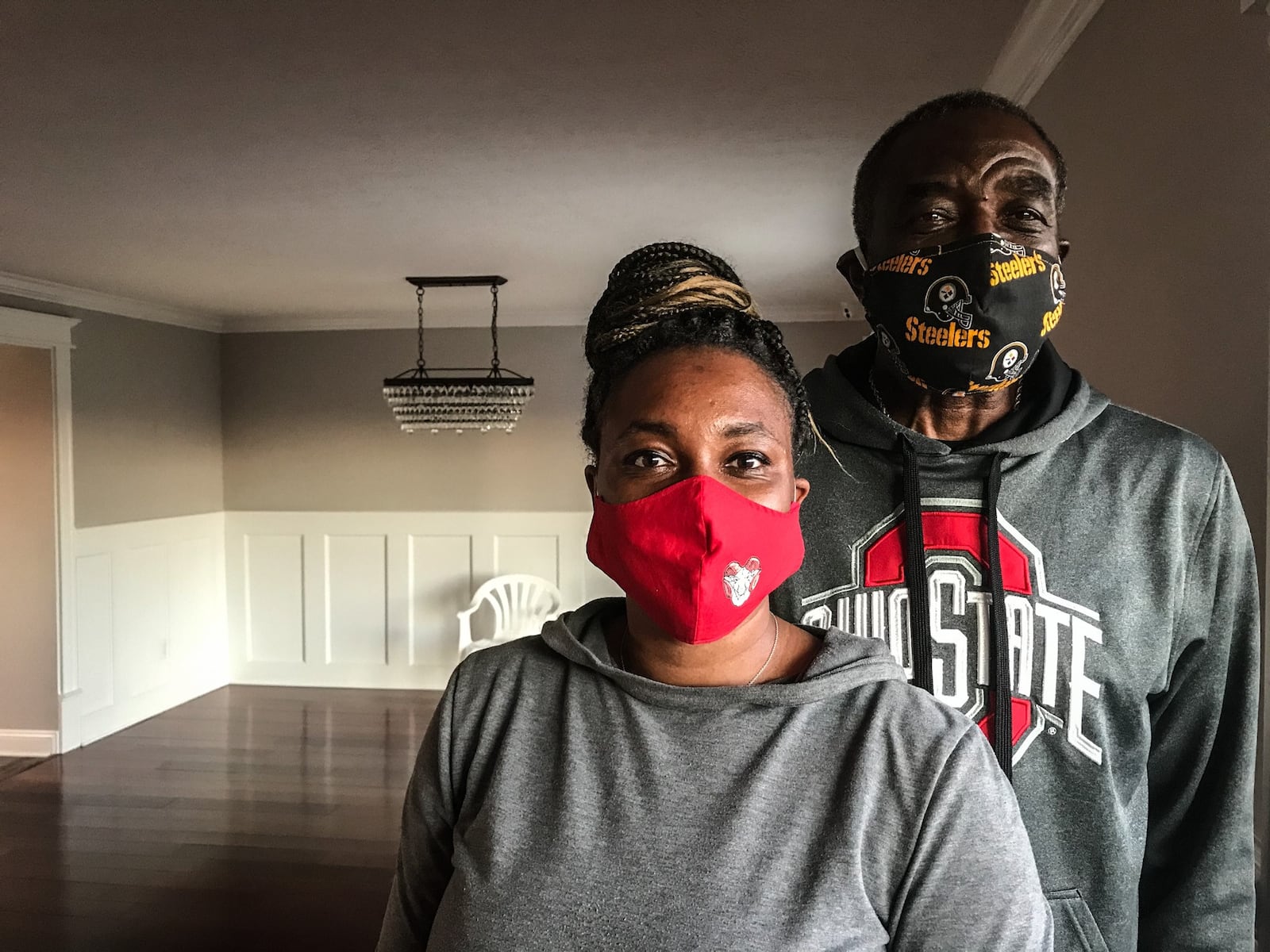 Tosha Johnson and her father, Wayne Johnson stand in their empty living room in Trotwood. The family home was nearly destroyed by the 2019 Memorial Day tornados. The Johnson's furniture is stored in boxes on the driveway and soon will fill their rebuilt home.