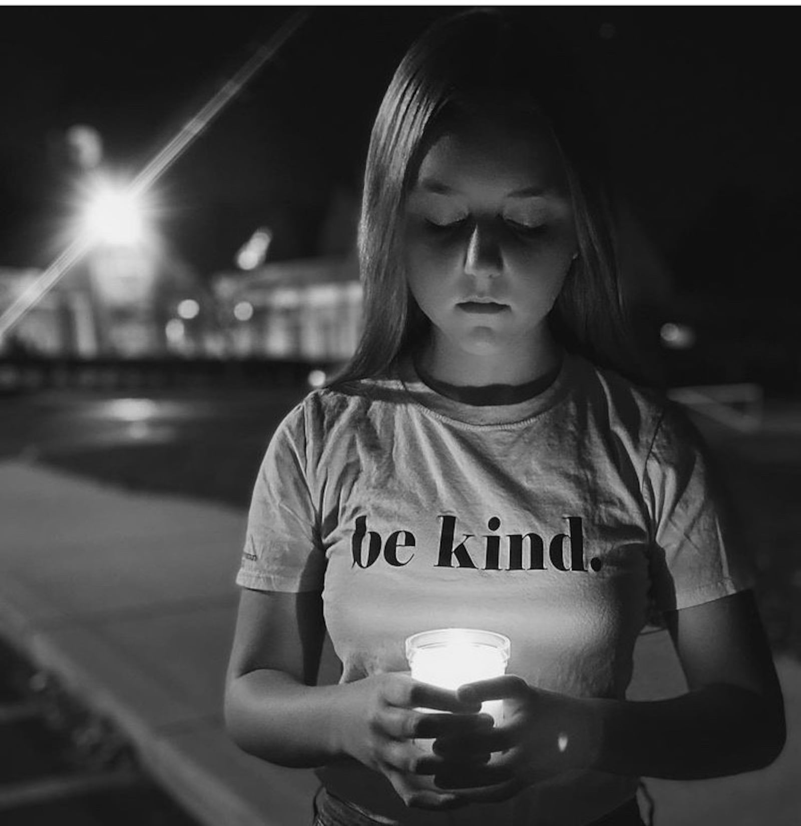 Reese Hornick holding a candle outside a memorial Mass at St. Charles Borromeo in November 2020 (the Mass they have every year to honor those who were lost in the past year).  Contributed photo