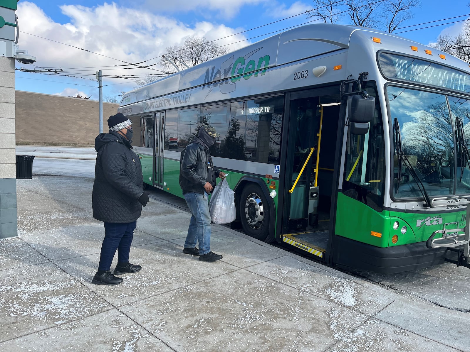 Passengers board a bus at the Eastown Transit Center. CORNELIUS FROLIK / STAFF