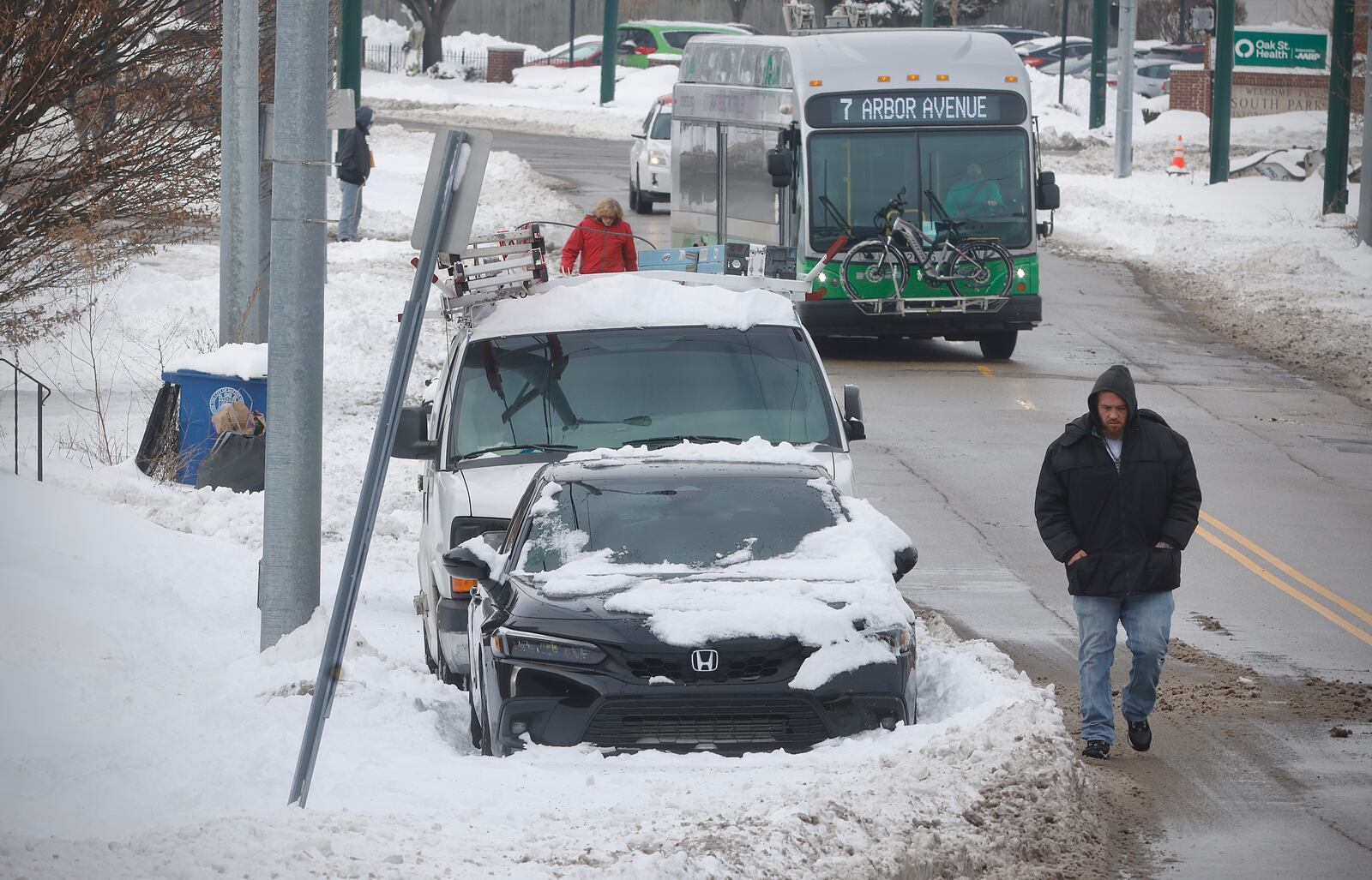 With most roads in the area and being cleared, the sidewalks still remain snow covered, causing pedestrians to have to take to the streets Wednesday, Jan. 8, 2025 like on Wyoming Street in Dayton. MARSHALL GORBY/STAFF