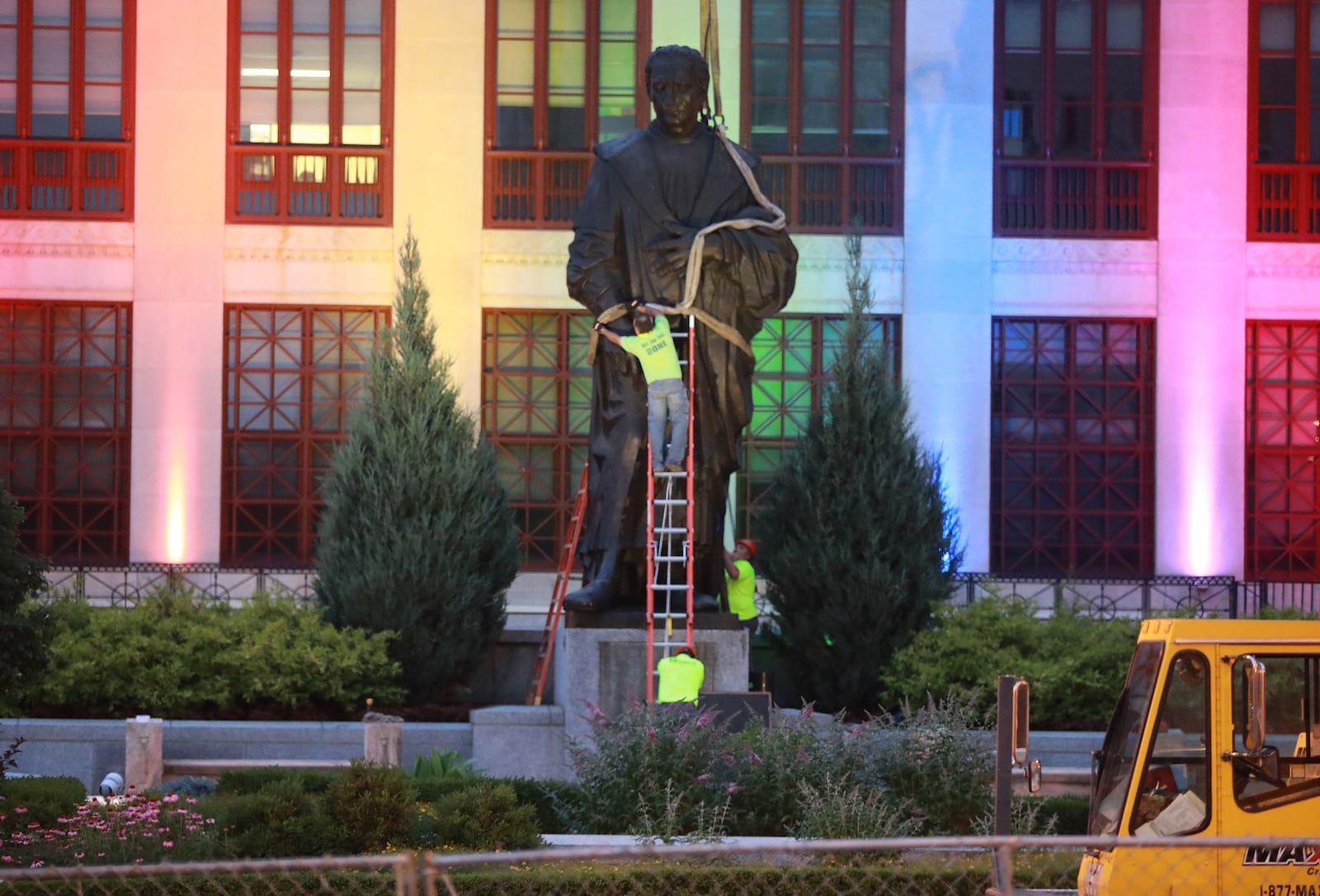 Workers remove the Christhopher Columbus statue on the Broad Street side of Columbus City Hall Wednesday, July 1, 2020.  The city says it will be replaced with a different statue or artwork that reflects diversity. A city news releaase said it will be placed in safekeeping at a secure city facility. The Christopher Columbus statue was a gift from the people of Genoa, Italy, in 1955.  (Doral Chenoweth/Columbus Dispatch)