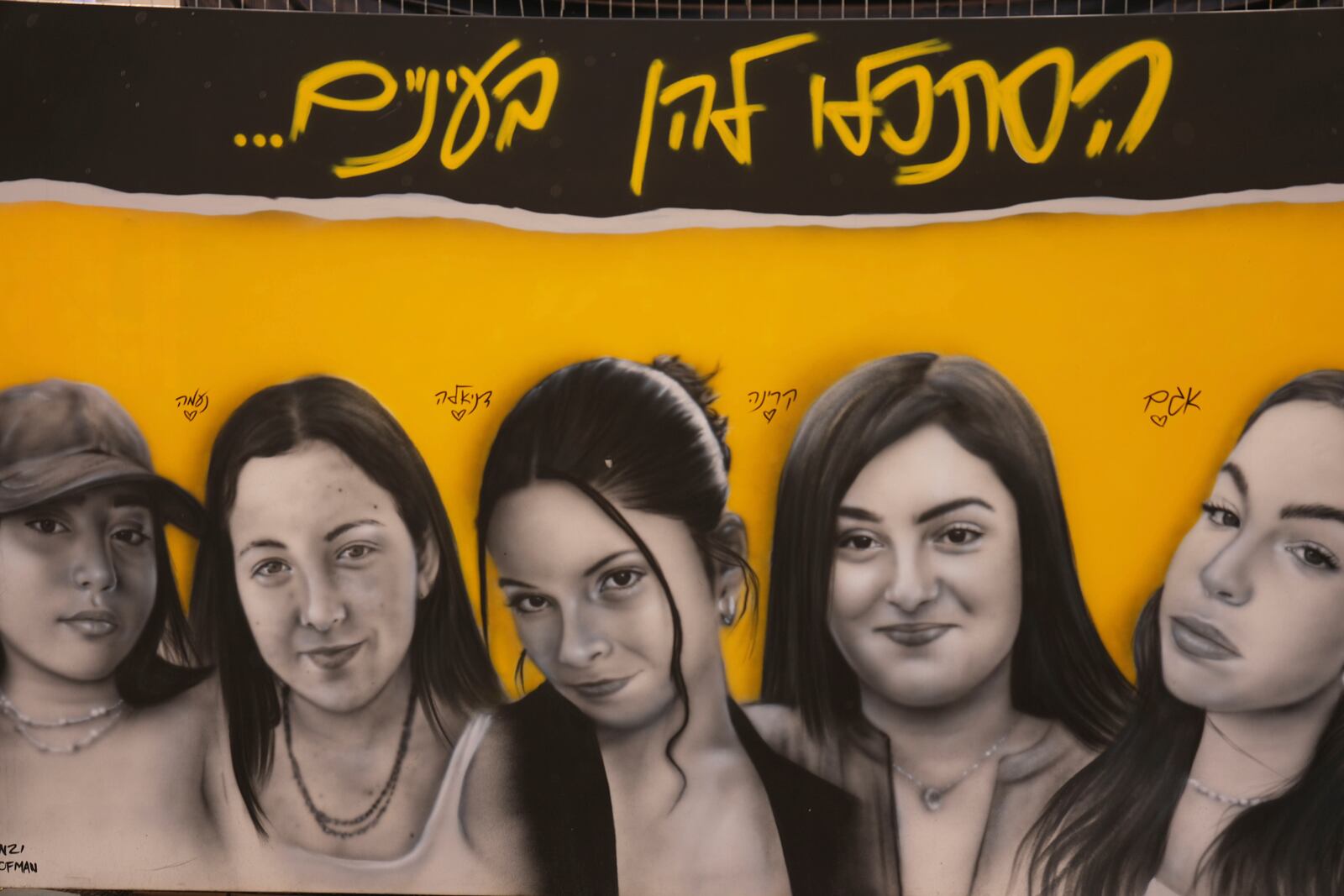 A mural of female Israeli soldiers held hostage by the Hamas militant group in the Gaza Strip is displayed in Tel Aviv, Israel, Saturday, Jan. 25, 2025. (AP Photo/Ariel Schalit)