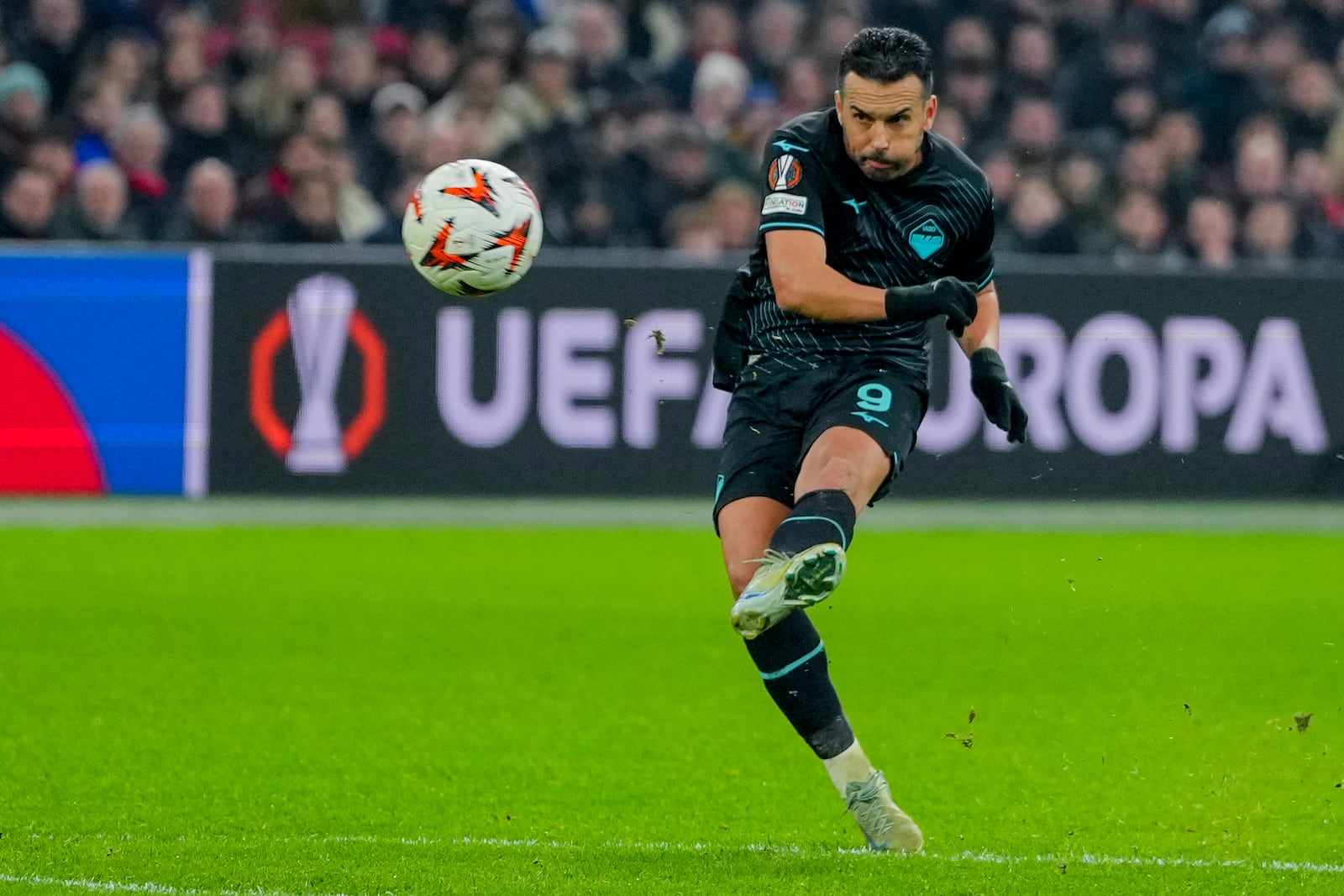 Lazio's Pedro kicks the ball during the Europa League soccer match between Ajax and Lazio Roma at the Johan Cruyff Arena in Amsterdam, Netherlands, Thursday, Dec. 12, 2024. (AP Photo/Peter Dejong)