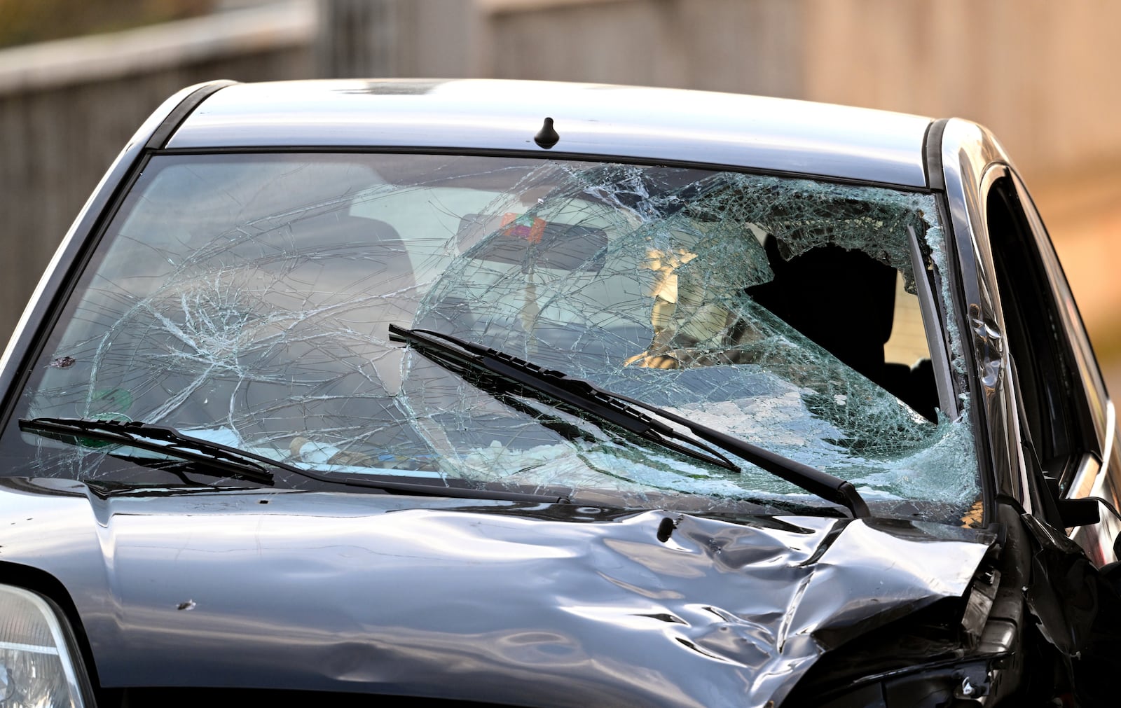 A damaged vehicle stands on an access road to the Rhine bridge, in Mannheim, Germany, Monday, March 3, 2025, following an incident when a car rammed into a crowd, German police said. (Boris Roessler/dpa via AP)