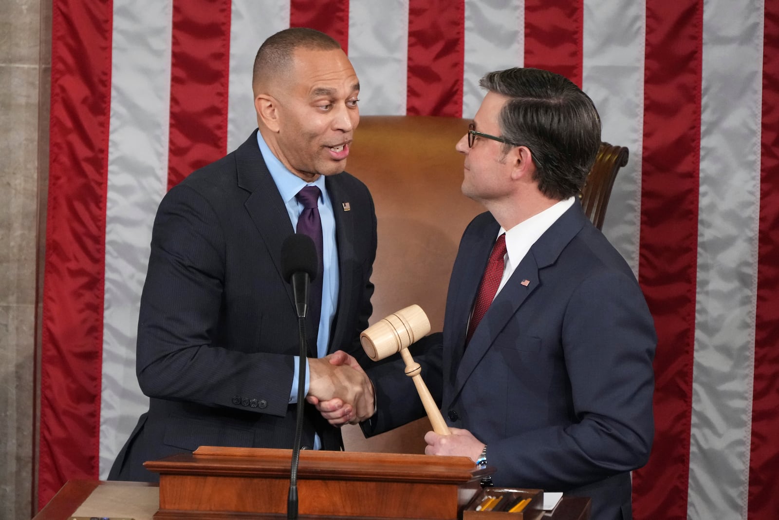 House Minority Leader Hakeem Jeffries, D-N.Y., left, hands the gavel to House Speaker Mike Johnson, R-La., in a customary nod to the peaceful transfer of power as the House of Representatives meets to elect a speaker and convene the new 119th Congress at the Capitol in Washington, Friday, Jan. 3, 2025. (AP Photo/Jacquelyn Martin)