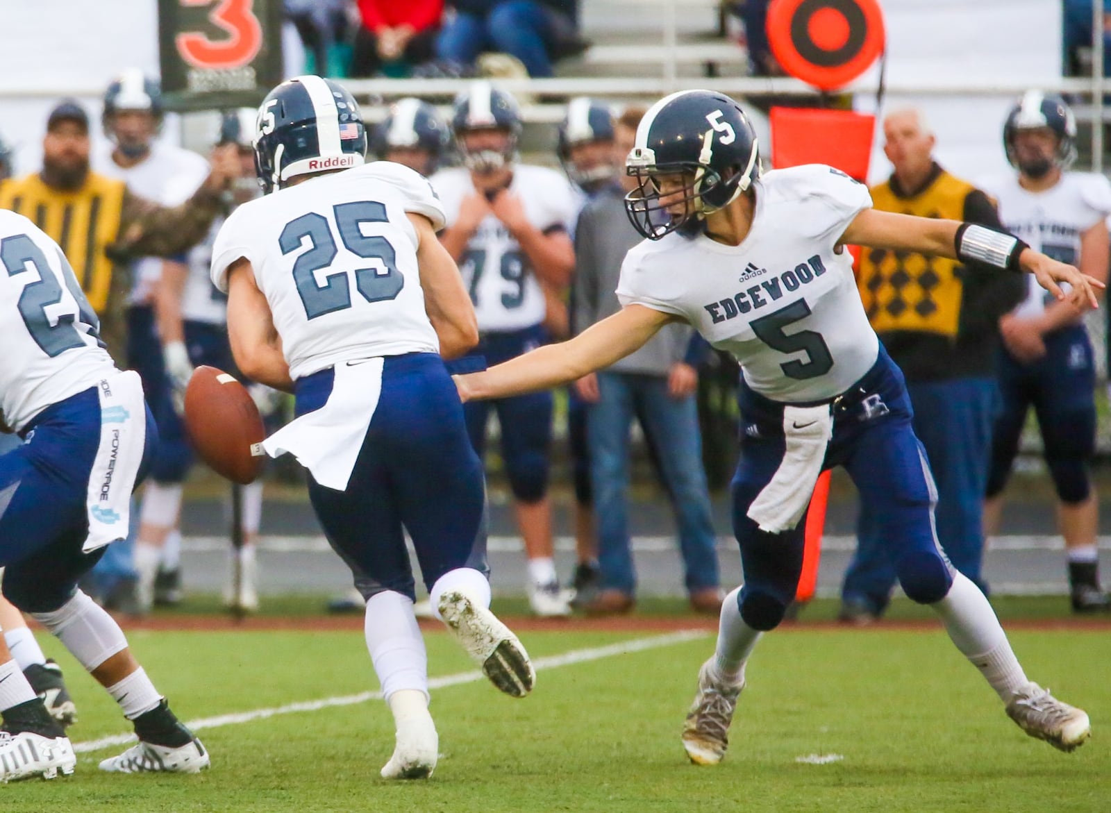 Edgewood quarterback Corbin Craft (5) and running back Wade Phillips (25) have a bad exchange during Friday night’s game against Franklin at Atrium Stadium in Franklin. GREG LYNCH/STAFF