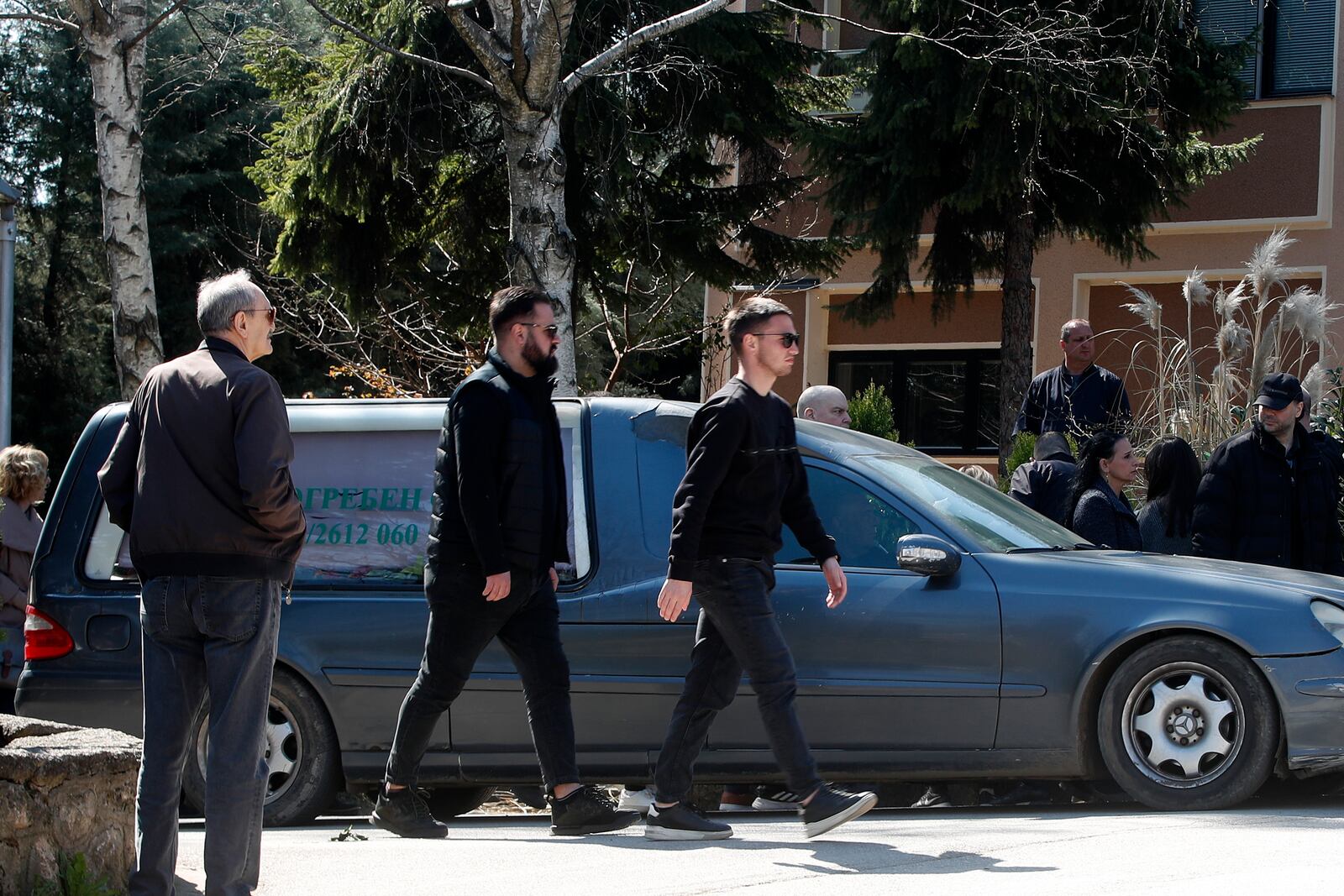 People attend the funeral of Andrej Gjorgieski, one of the lead singers of Macedonian band DNK, a victim of the March 16 nightclub fire in the town of Kocani, at a cemetery in Skopje, North Macedonia, Thursday, March 20, 2025. (AP Photo/Boris Grdanoski)