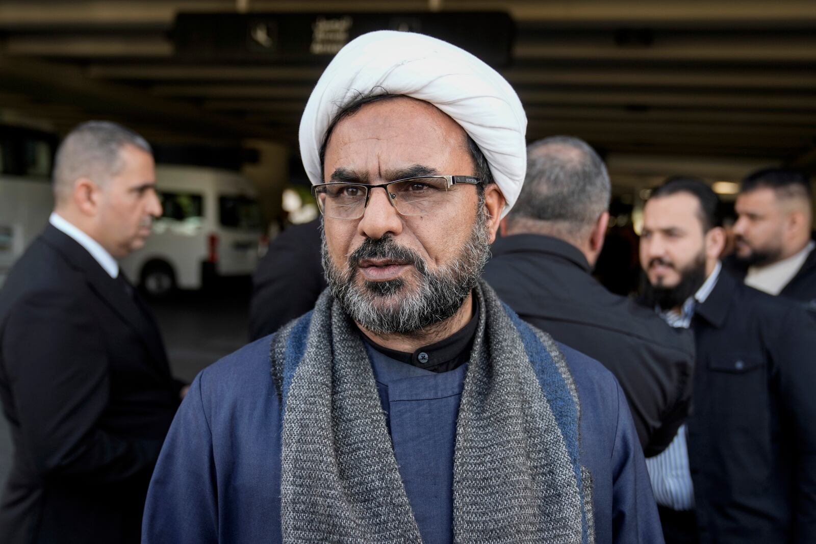 Sheikh Kazim al-Fartousi, spokesman for the Iran-backed Kataib Sayyid al-Shuhada, speaks during an interview with The Associated Press upon his arrival at the Rafik Hariri International Airport, in Beirut, Lebanon, Friday, Feb. 21, 2025. (AP Photo/Bilal Hussein)