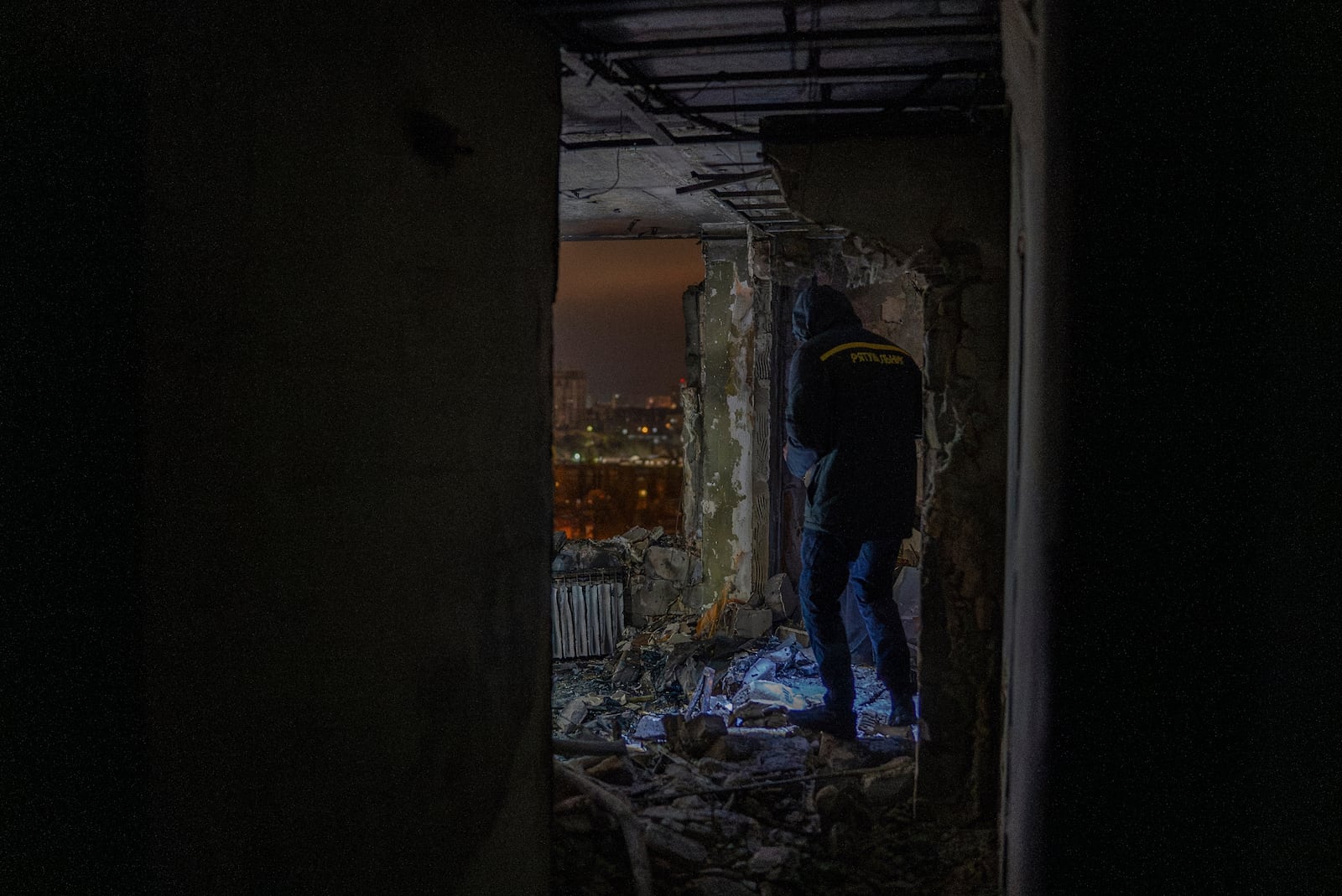 A firefighter observes the site of the Russian drone attack that killed a teenager in Kyiv, Ukraine, early Saturday, Oct. 26, 2024. (AP Photo/Alex Babenko)