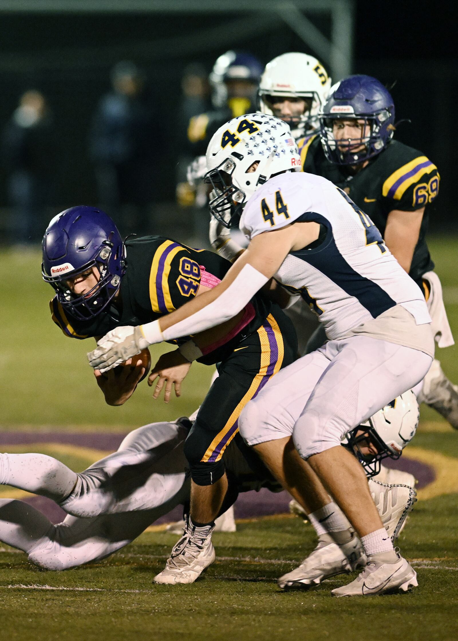 Monroe's Wyatt McPherson (44) tackles Bellbrook's Tanner Stewart during Friday night's game. Nick Falzerano/CONTRIBUTED