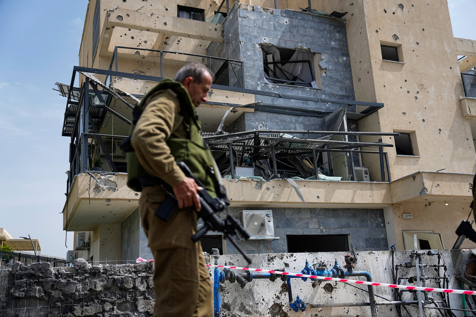 FILE - Israeli security forces examine the site hit by a Hezbollah rocket fired from Lebanon, in Kiryat Shmona, northern Israel, Wednesday, March 27, 2024. (AP Photo/Ariel Schalit, File)