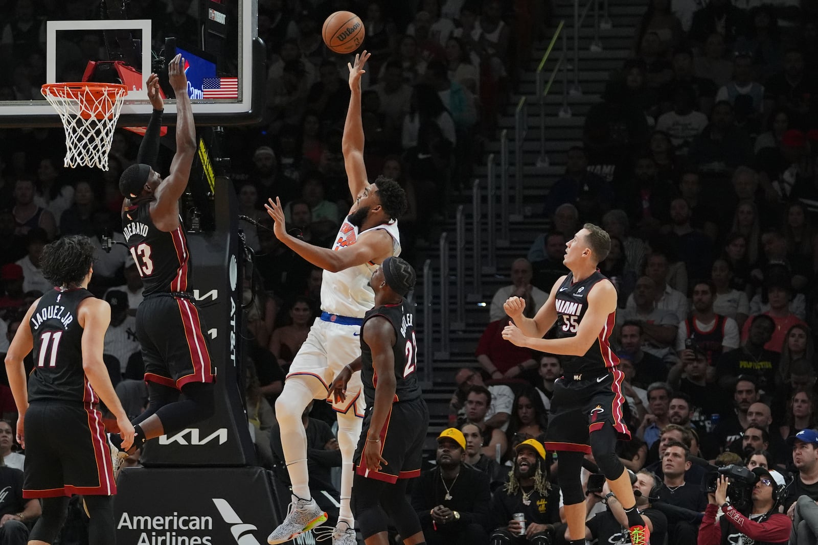 New York Knicks center Karl-Anthony Towns, center, goes to the basket as Miami Heat center Bam Adebayo (13) defends during the second half of an NBA basketball game, Wednesday, Oct. 30, 2024, in Miami. (AP Photo/Lynne Sladky)